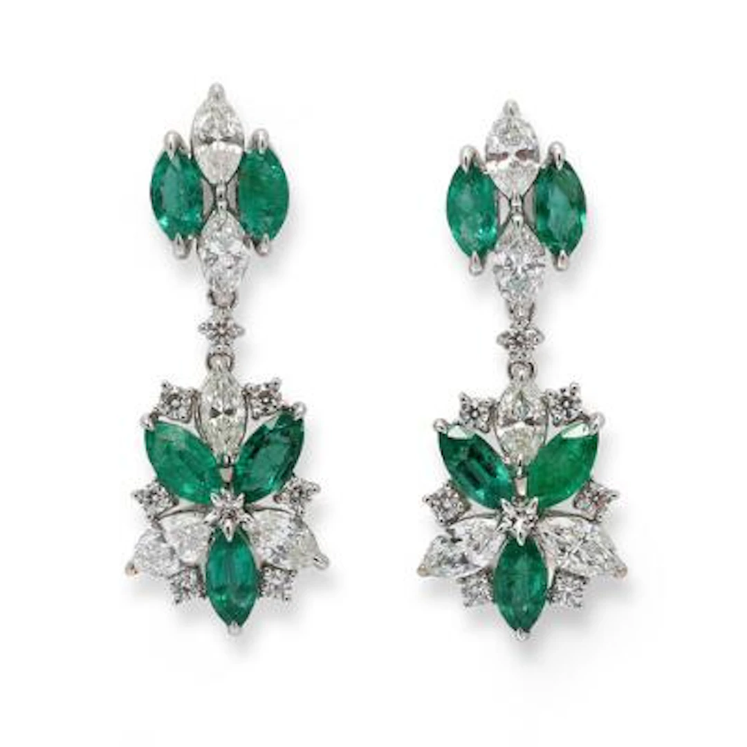 A pair of emerald ear studs set with emeralds and diamonds, mounted