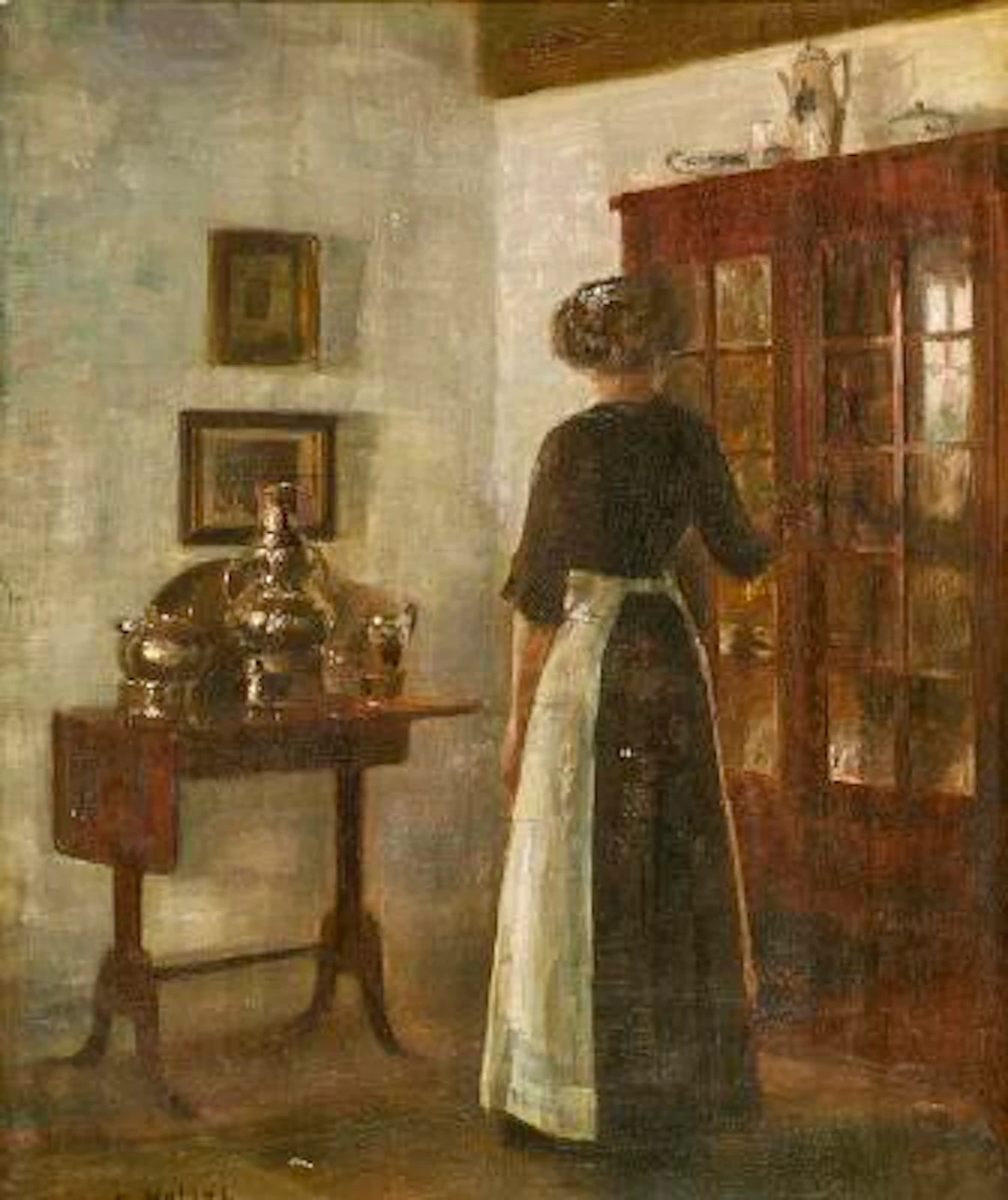 Carl Holsøe: Interior with a woman seen from behind. Signed C. Holsøe.