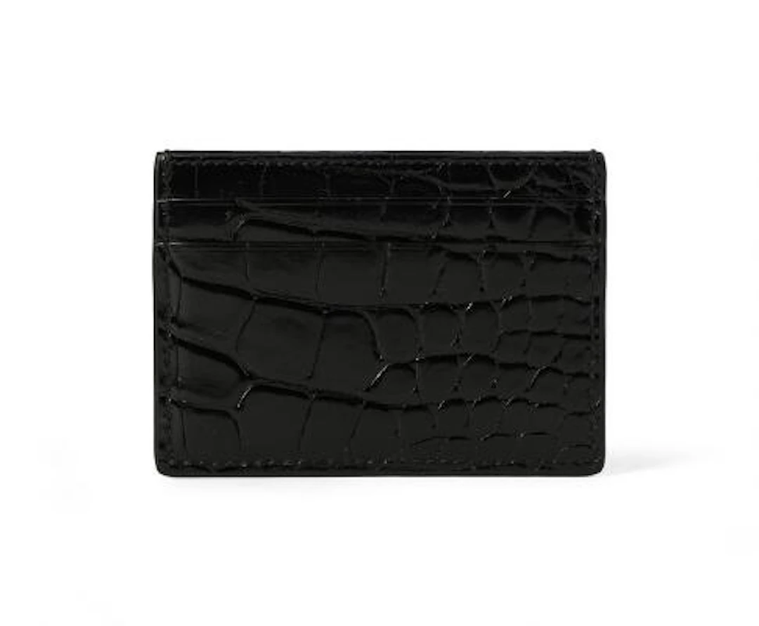 Gucci: A card holder of black crocodile skin and five card slots.