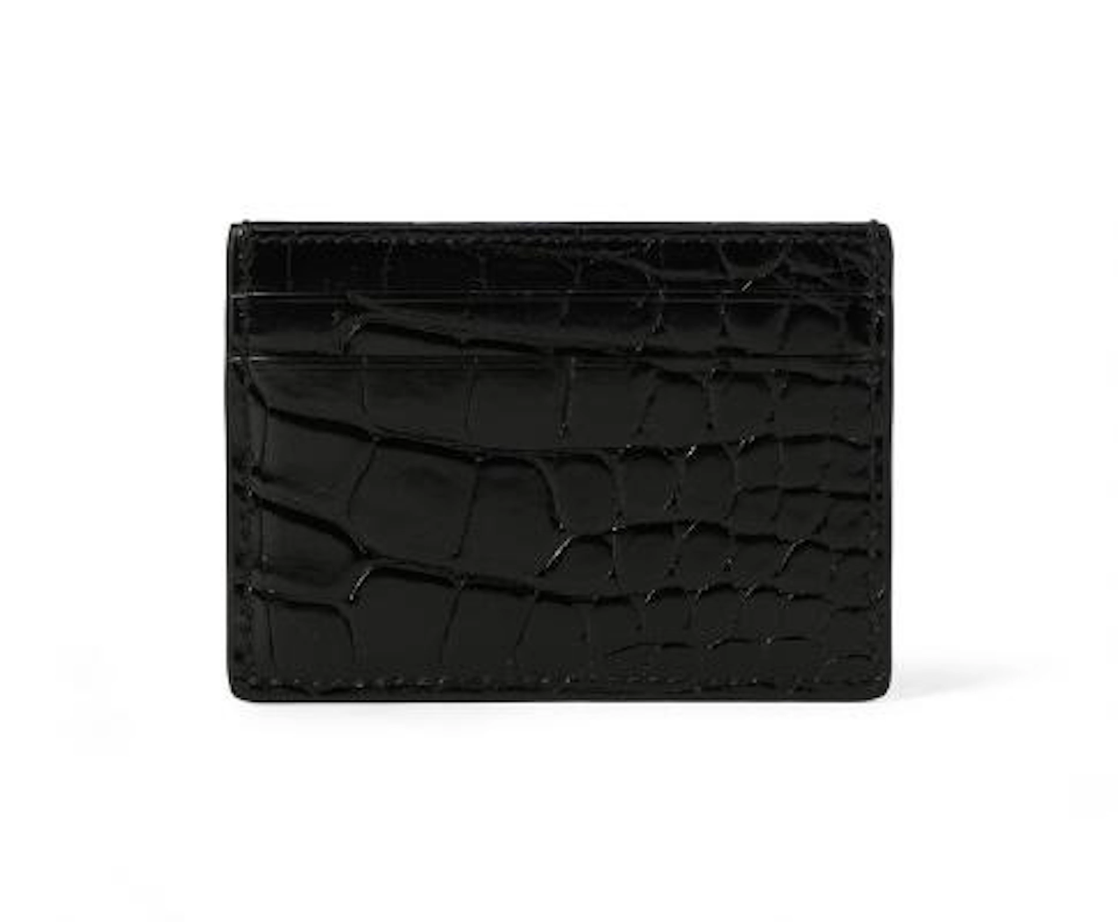 Gucci: A card holder of black crocodile skin and five card slots.