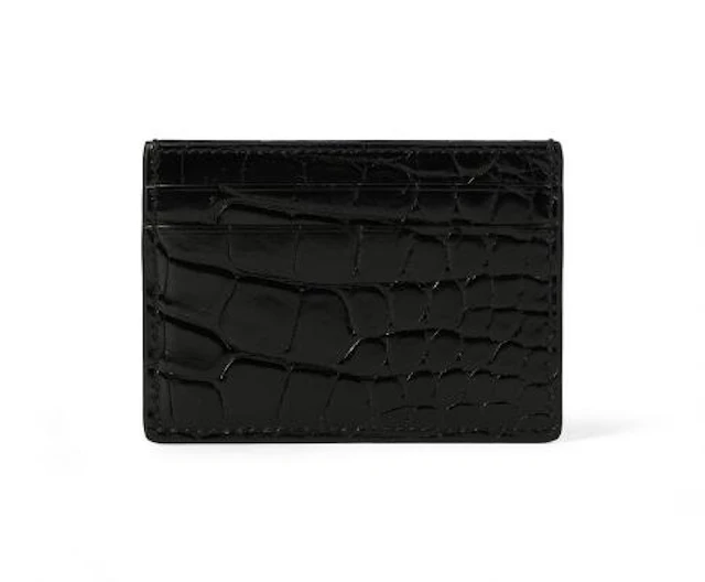Gucci: A card holder of black crocodile skin and five card slots.
