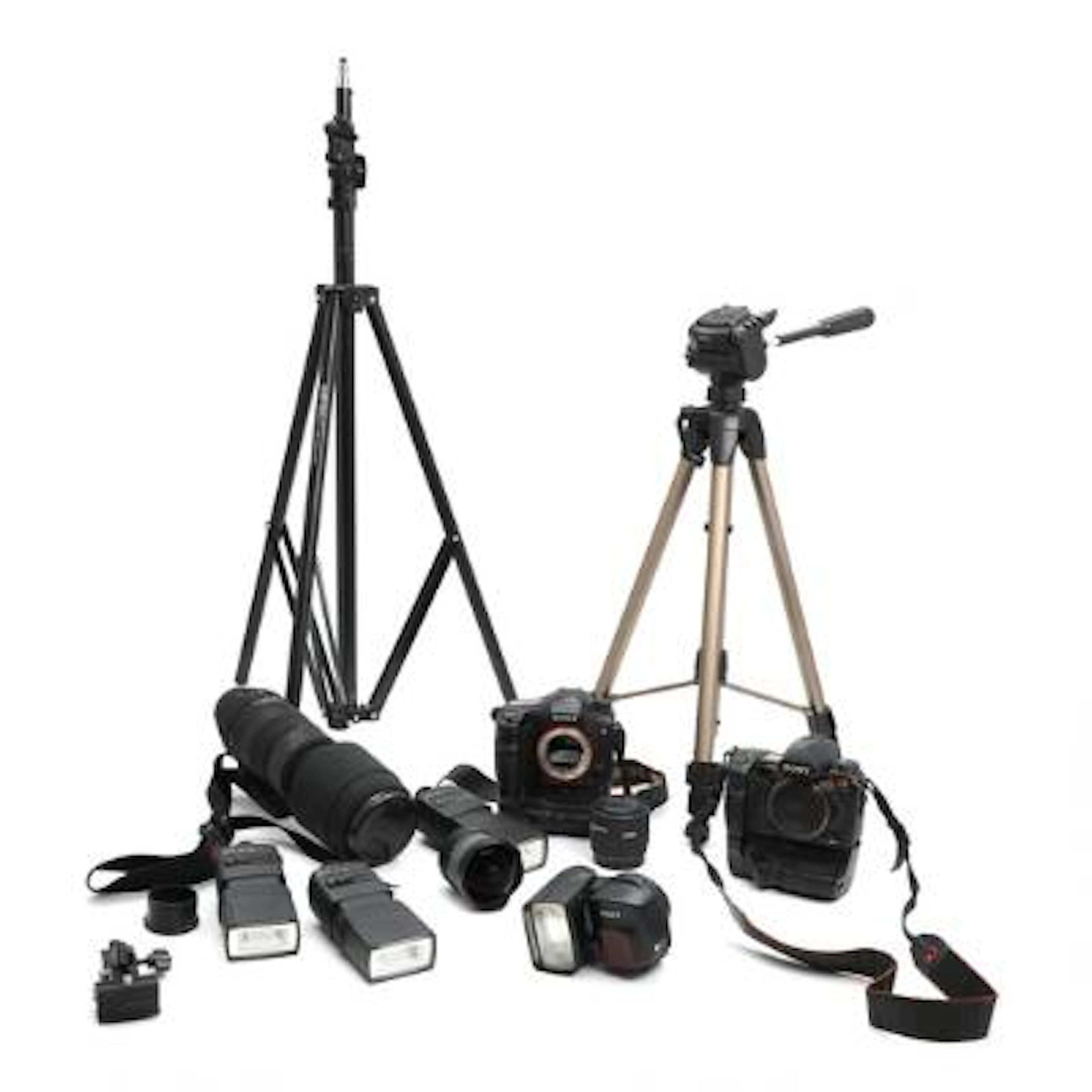 A collection of cameras and camera equipment, including two SLR cameras