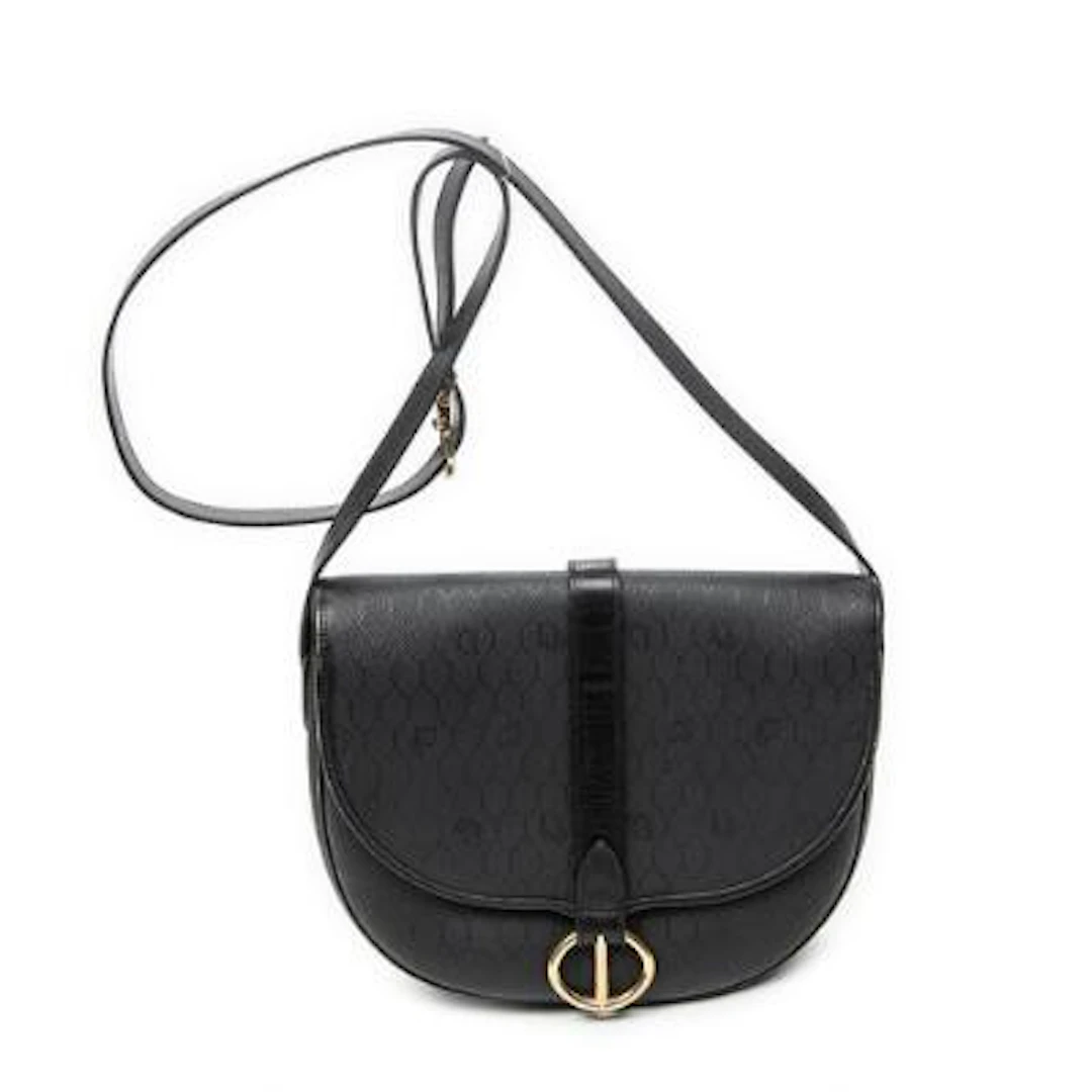 Dior: A "Vintage CD Flap Crossbody" in black coated canvas with an