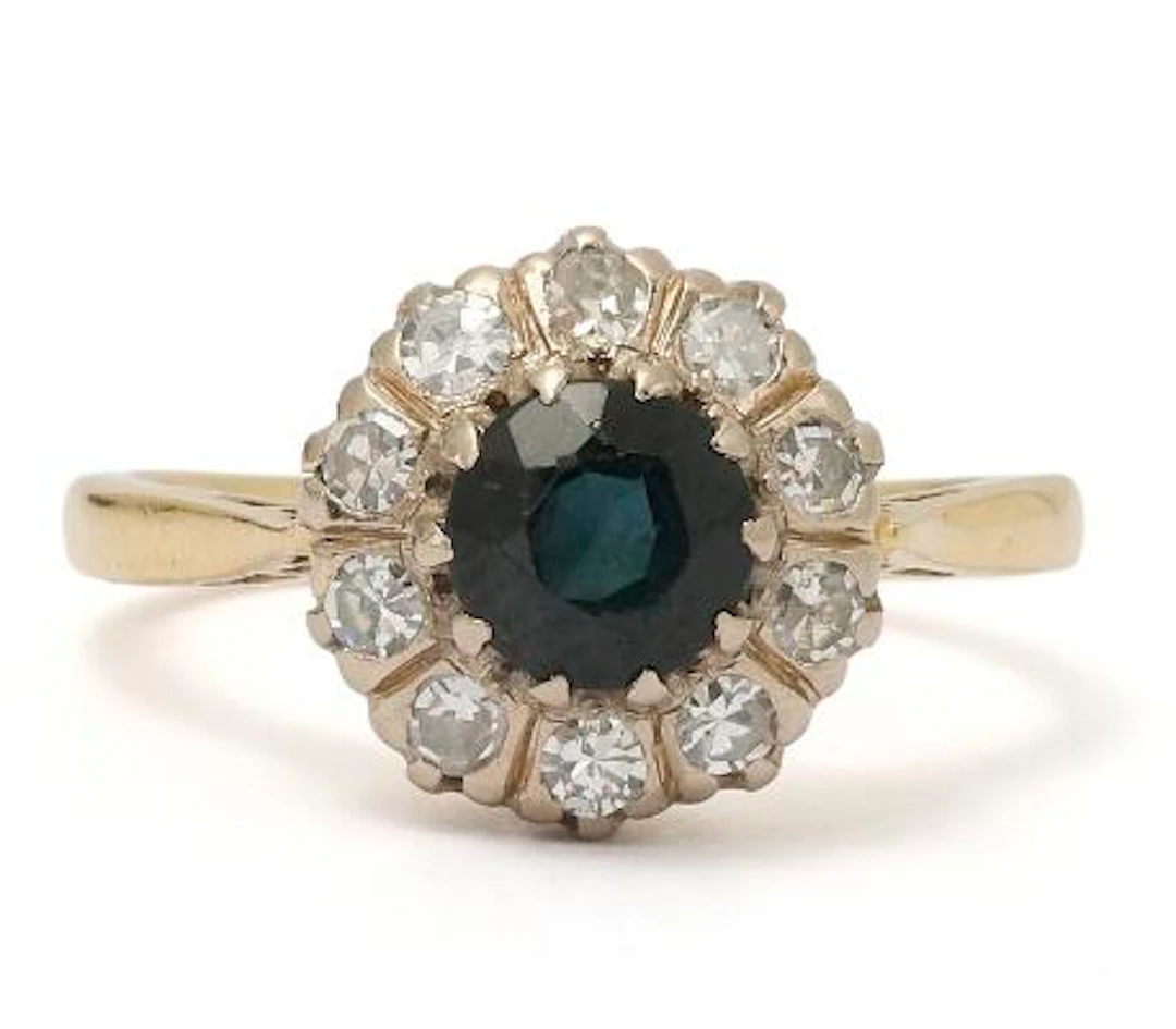 A sapphire and diamond ring set with a sapphire a nd numerous diamonds