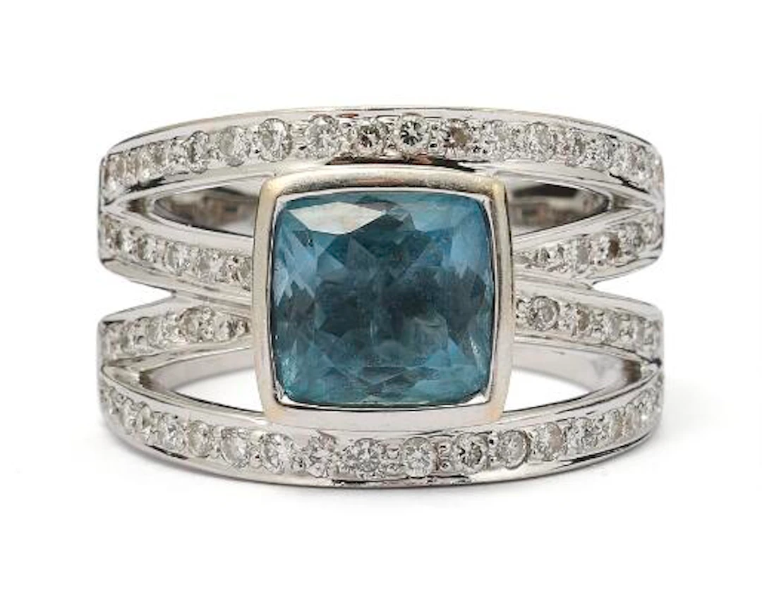 An aquamarine and diamond ring set with an aquamarine and diamonds