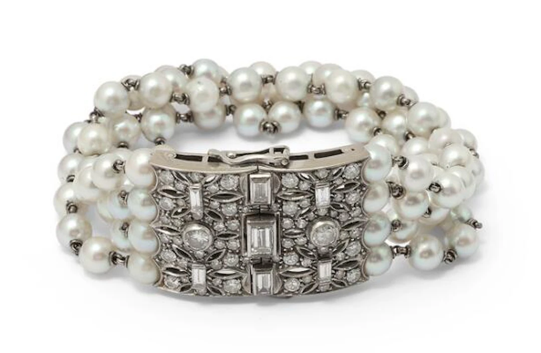 A four-strand pearl bracelet set with cultured pearls and a diamond