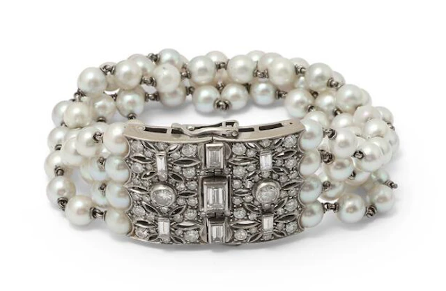 A four-strand pearl bracelet set with cultured pearls and a diamond
