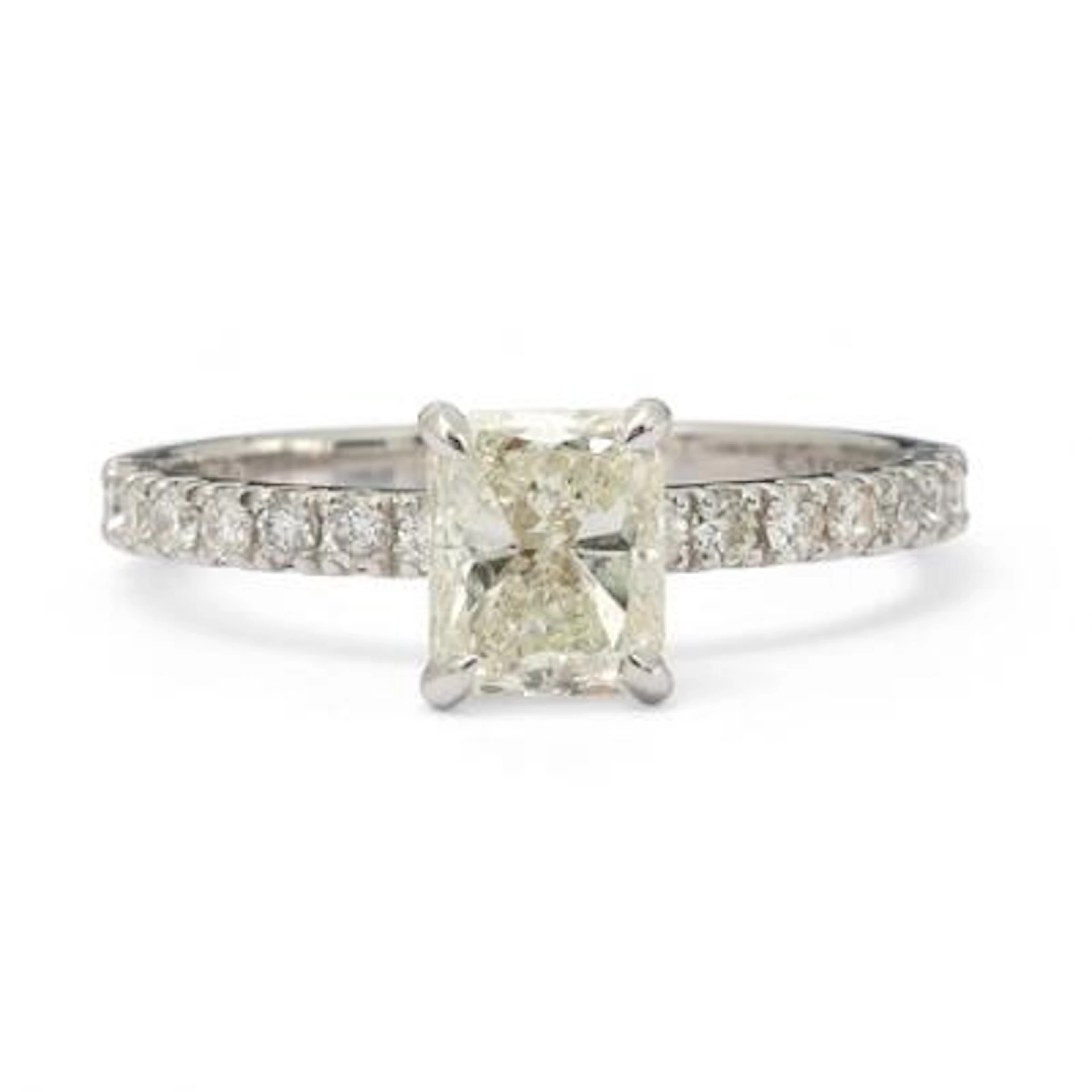 A diamond ring set with an emerald-cut diamond flanked by diamonds