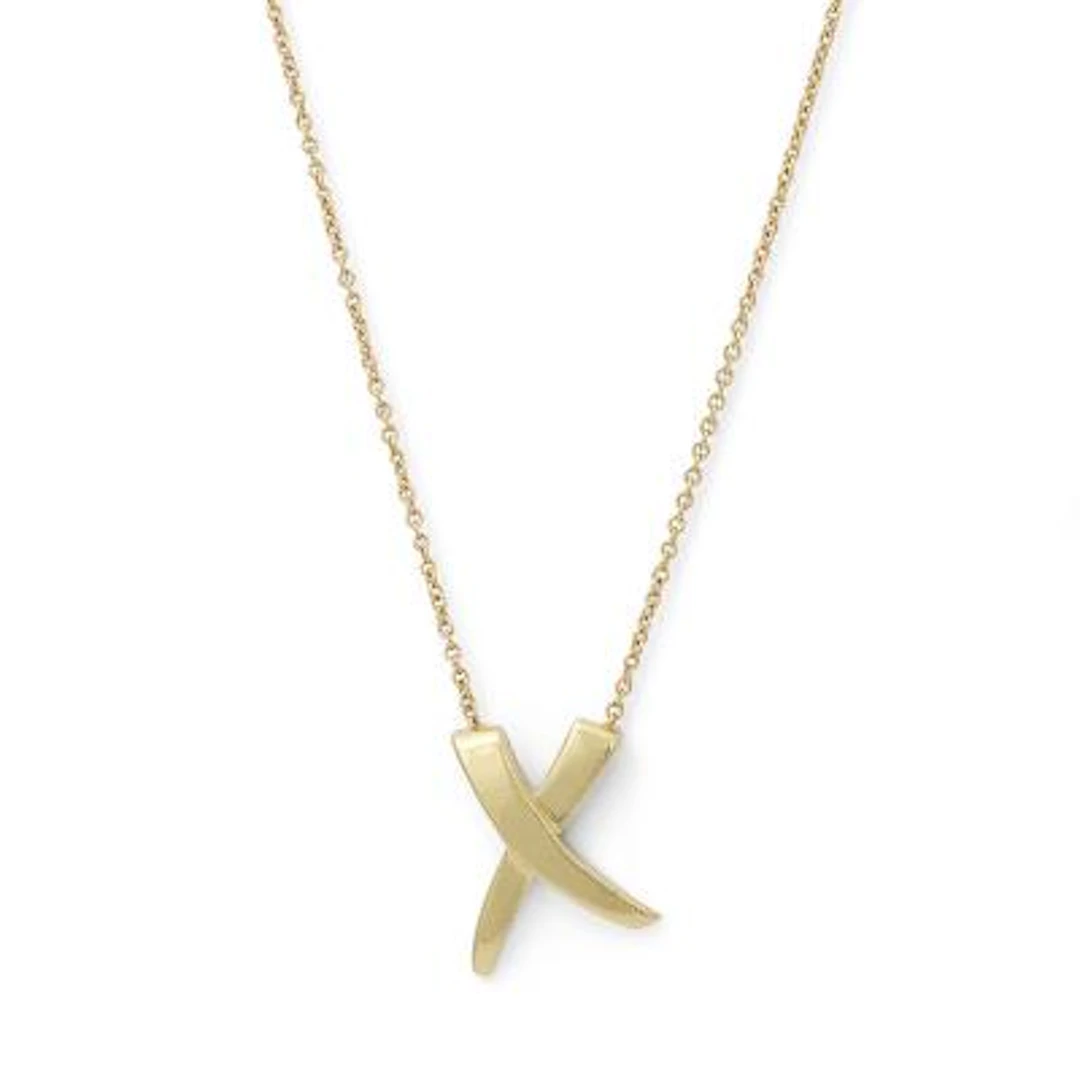 Tiffany & Co.: A "X Kiss" necklace with pendant of 18k gold. Weight