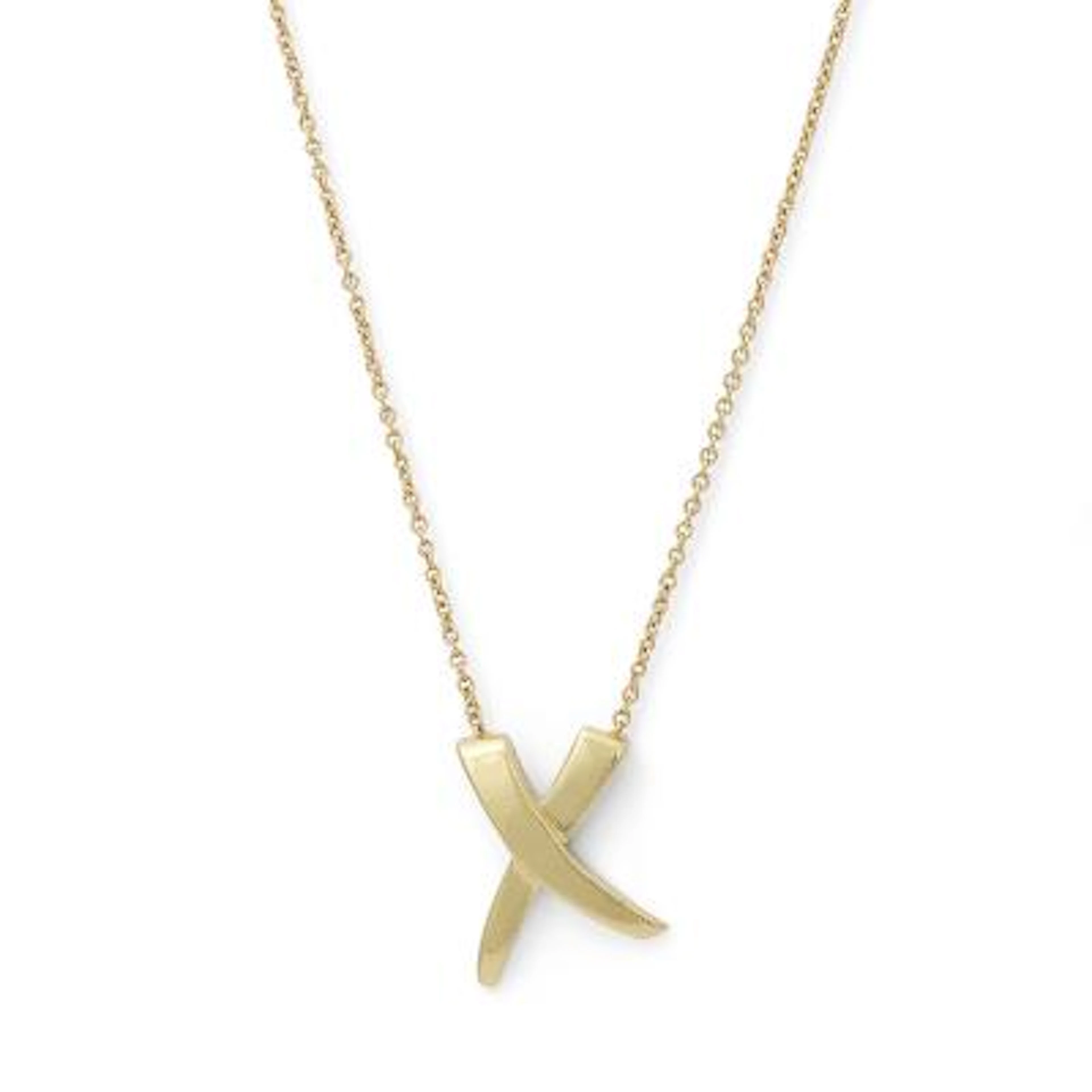 Tiffany & Co.: A "X Kiss" necklace with pendant of 18k gold. Weight