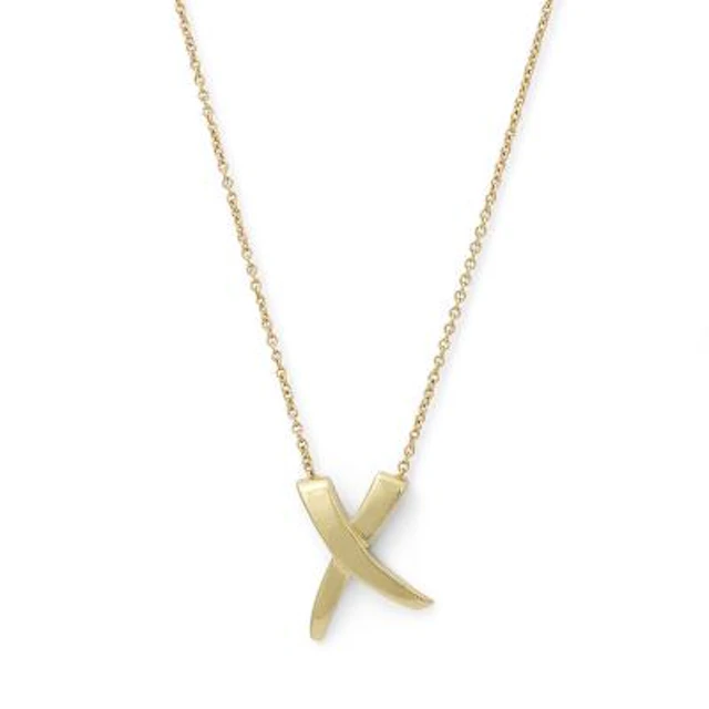 Tiffany & Co.: A "X Kiss" necklace with pendant of 18k gold. Weight