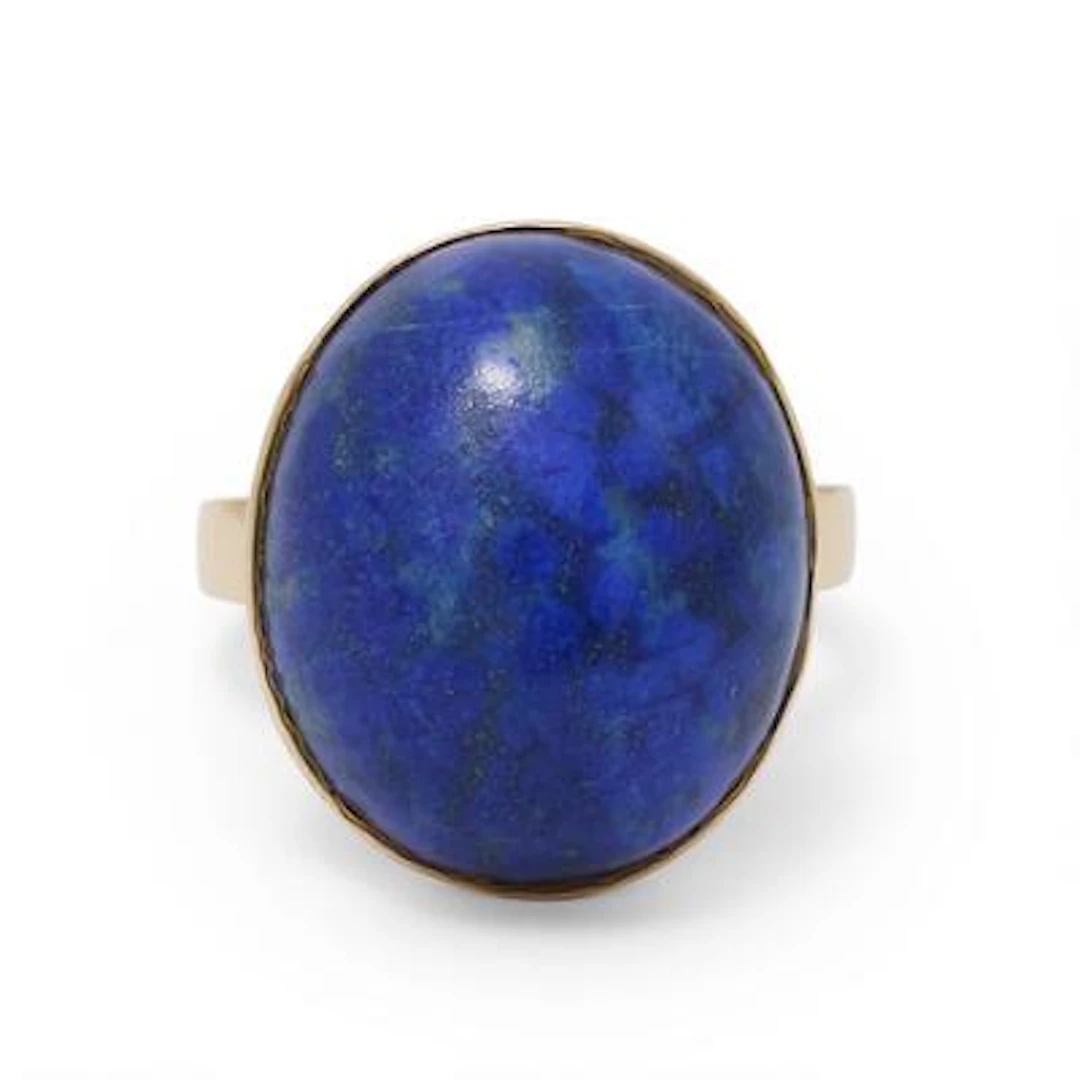 A lapis lazuli ring set with a cabochon lapis lazuli, mounted in 18k