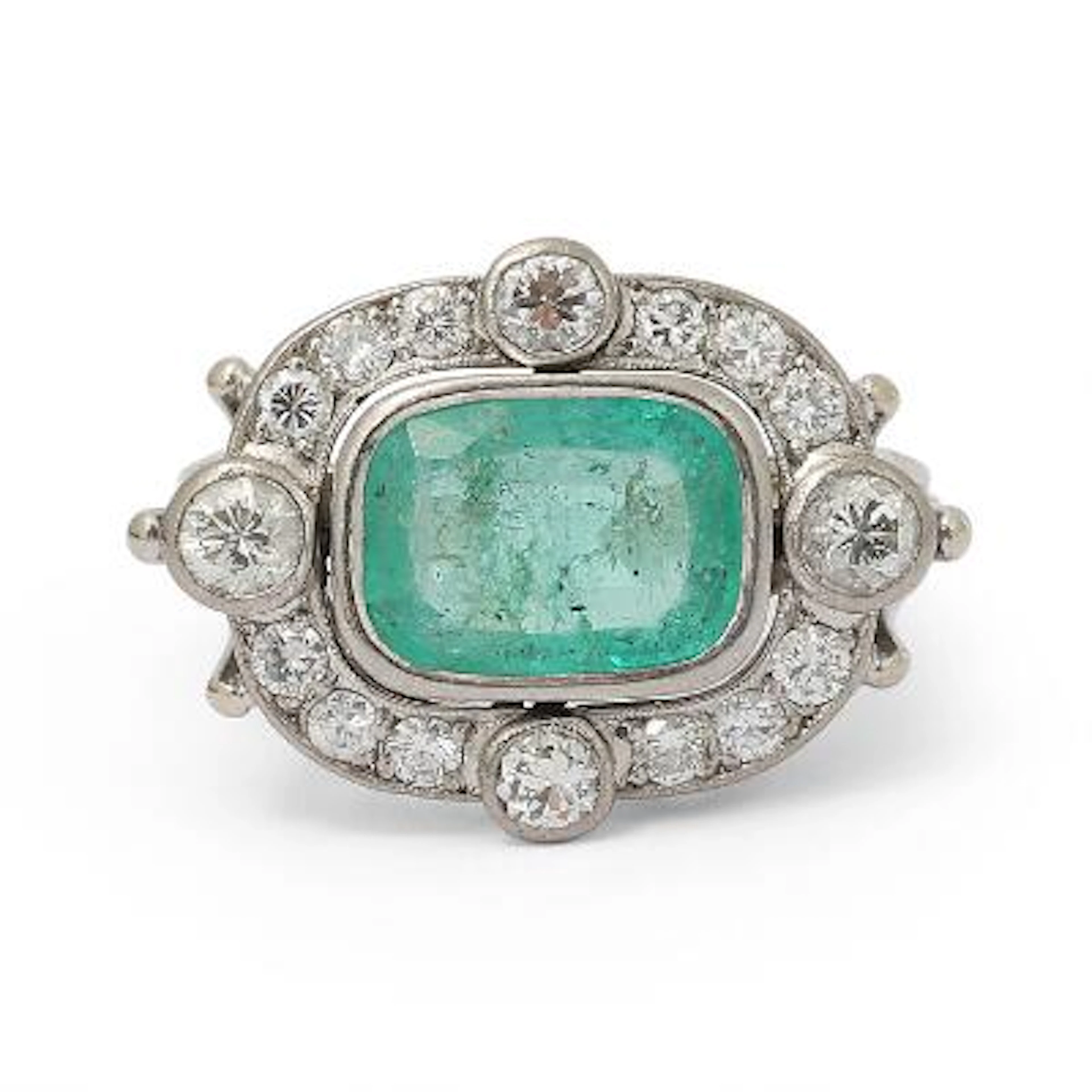 An emerald and diamond ring set with an emerald and diamonds, mounted