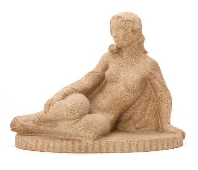 Asta Lilbæk: A sandstone sculpture in shape of a seated woman. Just