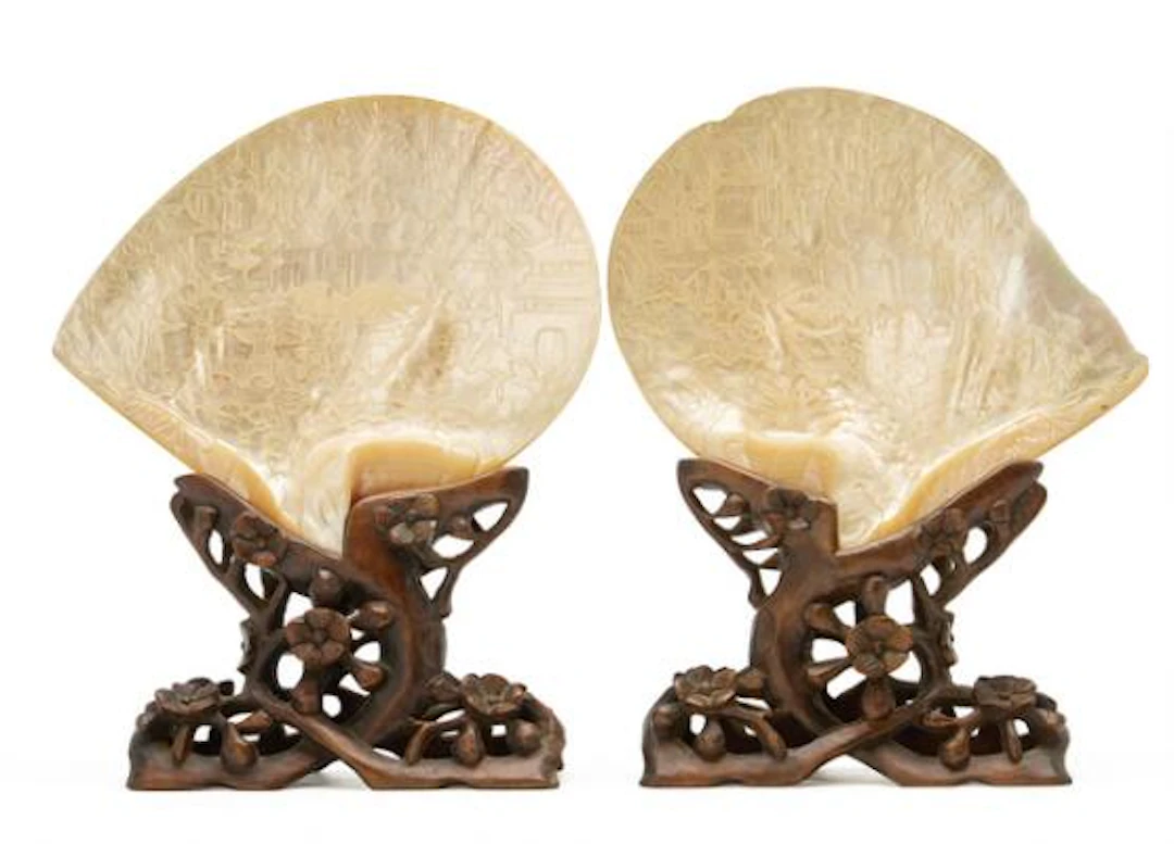 A pair of Canton mother-of-pearl shells carved with figurines and
