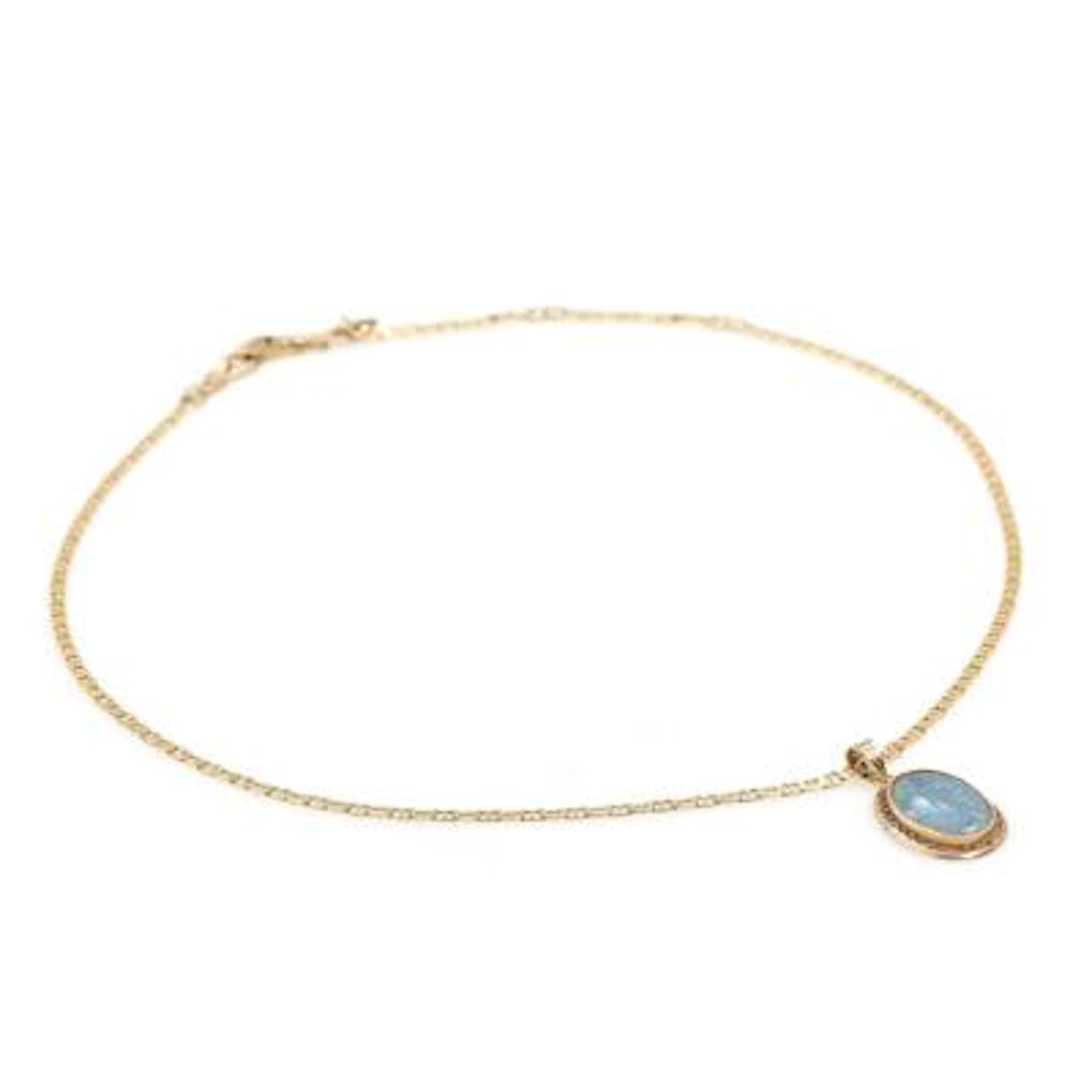 An opal pendant set with a cabochon opal triplet, mounted in 14k gold.