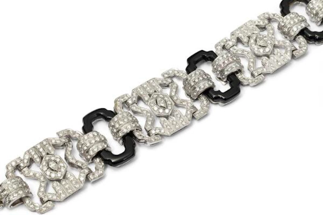 An Art Deco onyx and diamond bracelet of platinum and 18k gold. L.