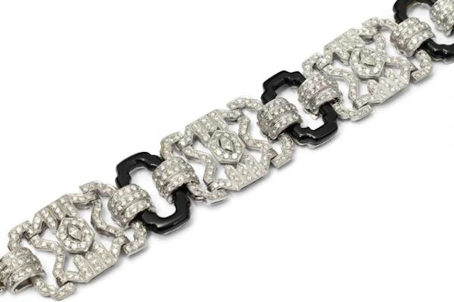 An Art Deco onyx and diamond bracelet of platinum and 18k gold. L.
