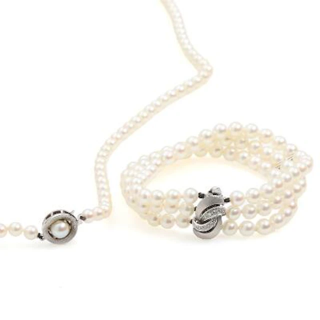 A cultured pearl bracelet with a 14k white gold and diamond clasp.