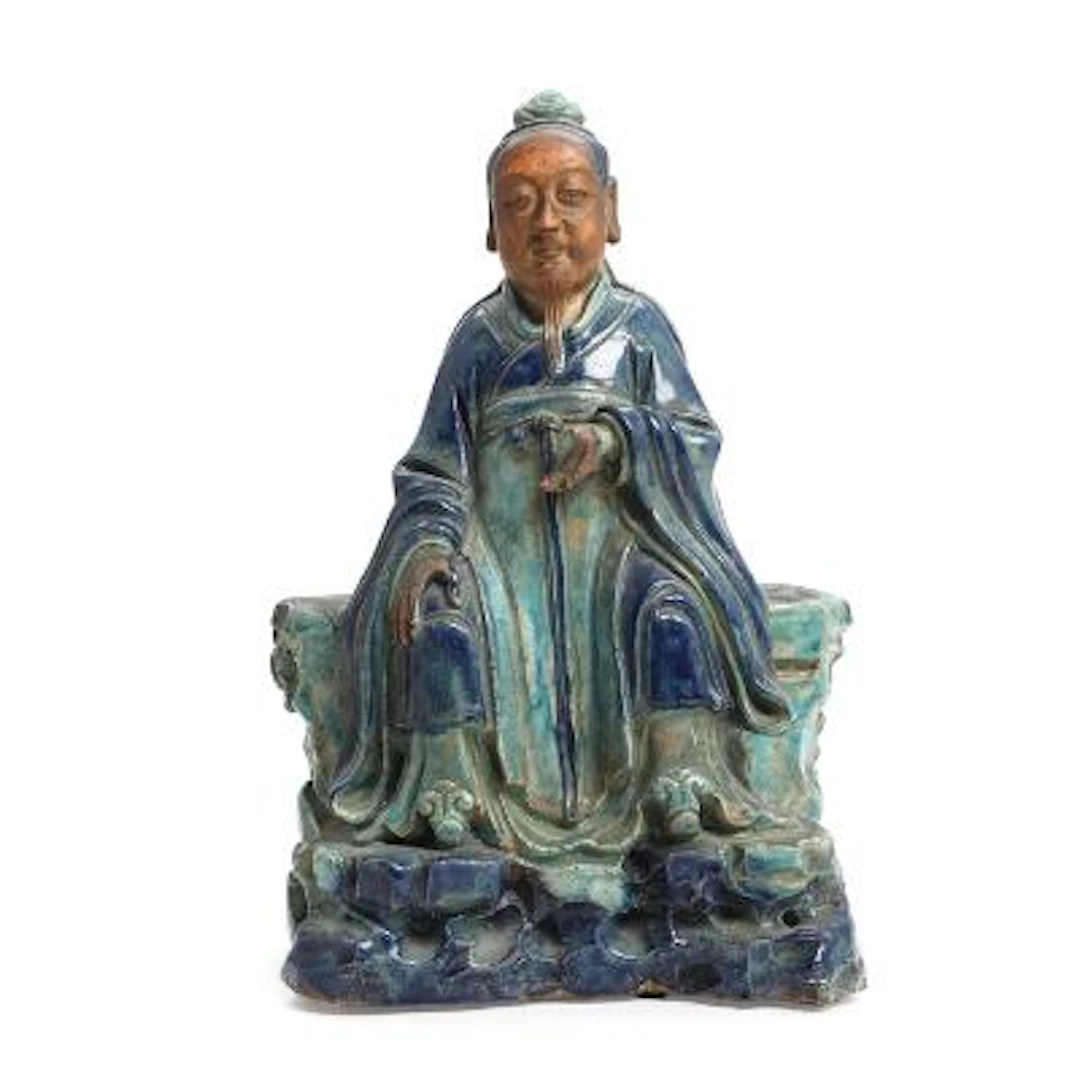 Chinese fahua pottery figure in the form of a wise man seated on a