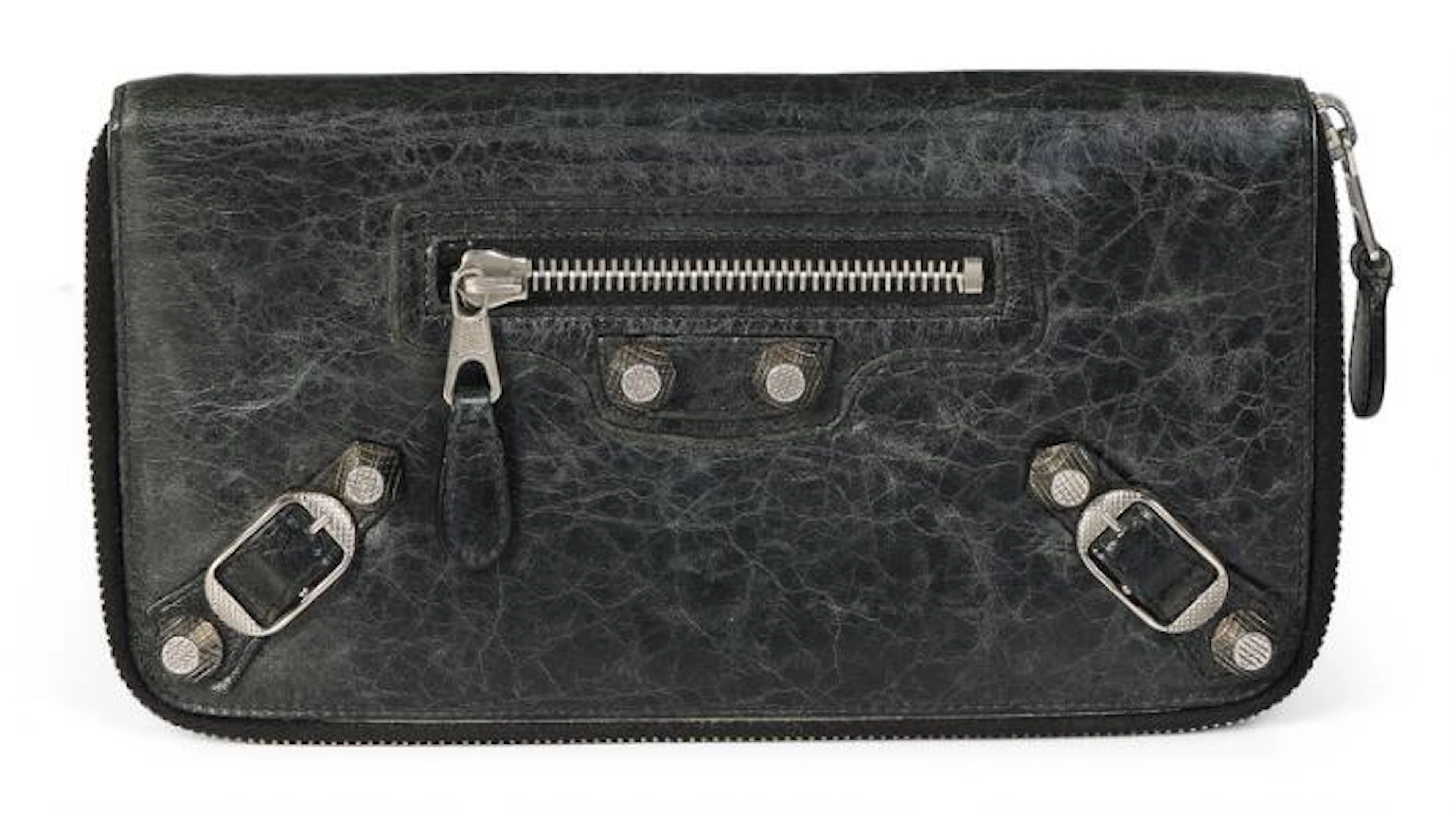 Balenciaga: A wallet of dark distressed leather with silver tone hardware