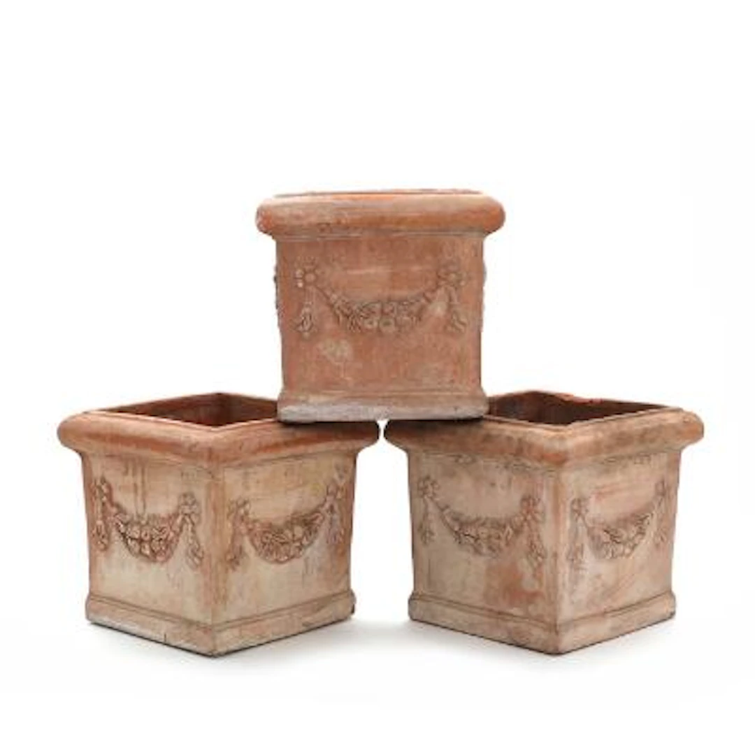 Three Italian terracotta flower urns, modelled with floral garlands