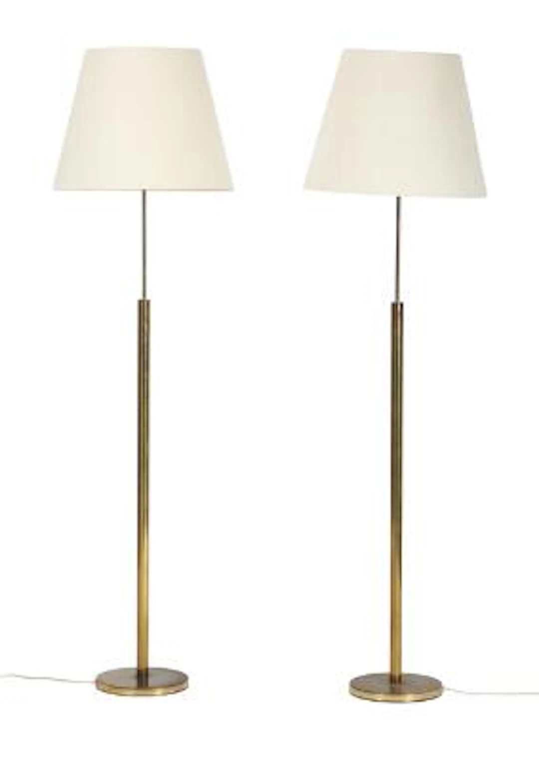 Danish design: A pair of brass floor lamps, mounted with shades with