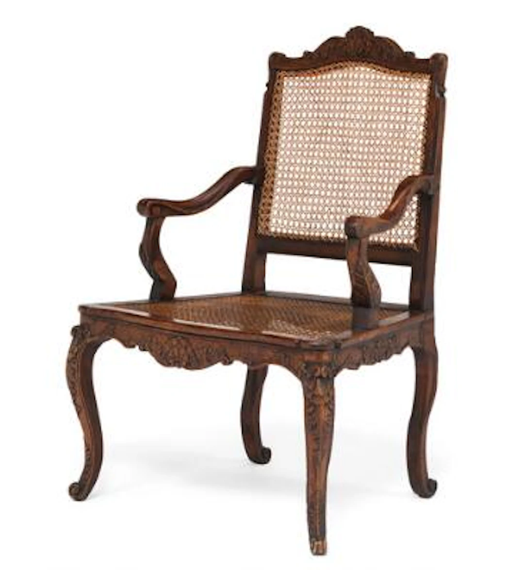 A French Louis XV tinted beechwood caned fauteuil. Paris c. 1730-1740.