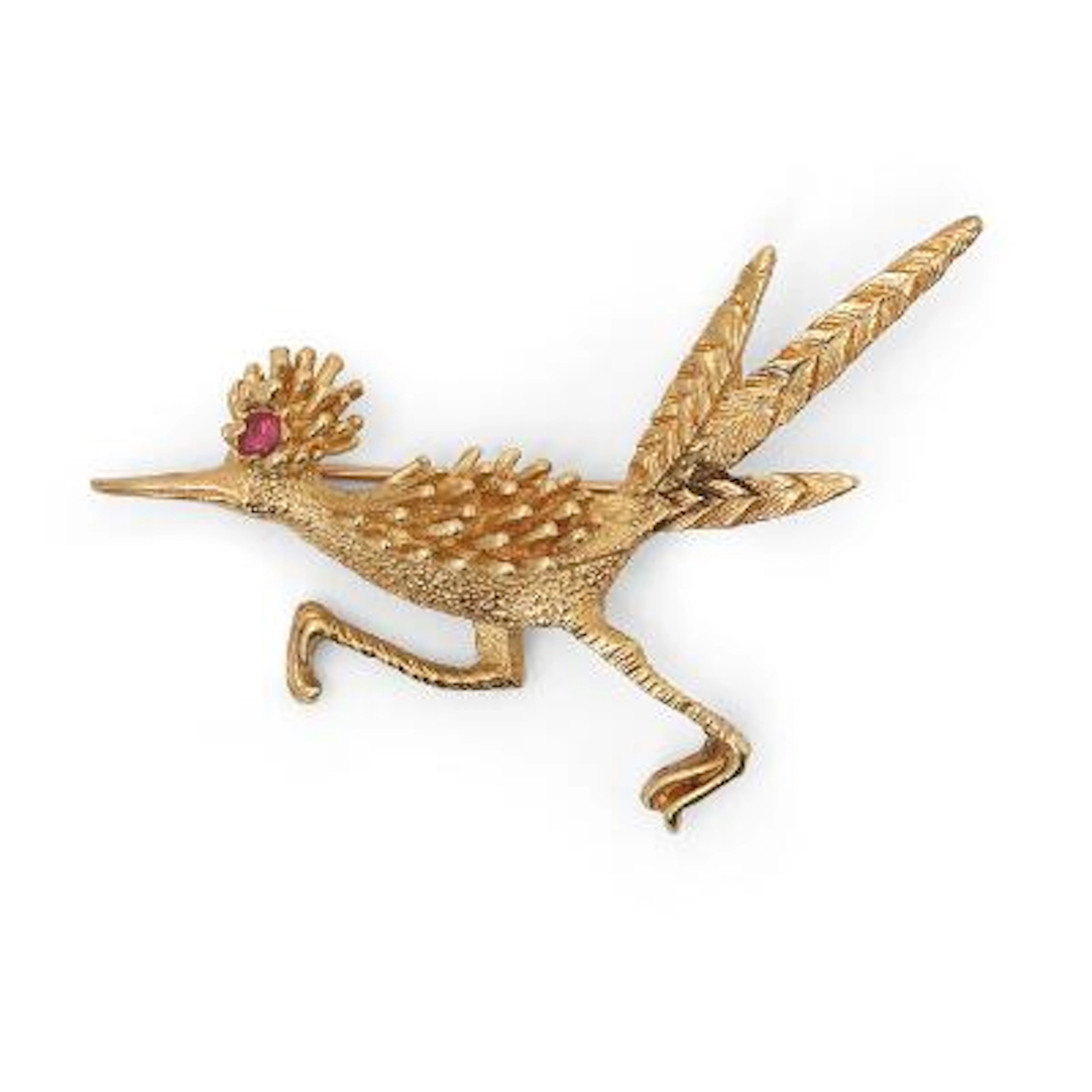 A brooch in shape of a roadrunner set with a circular-cut ruby, mounted
