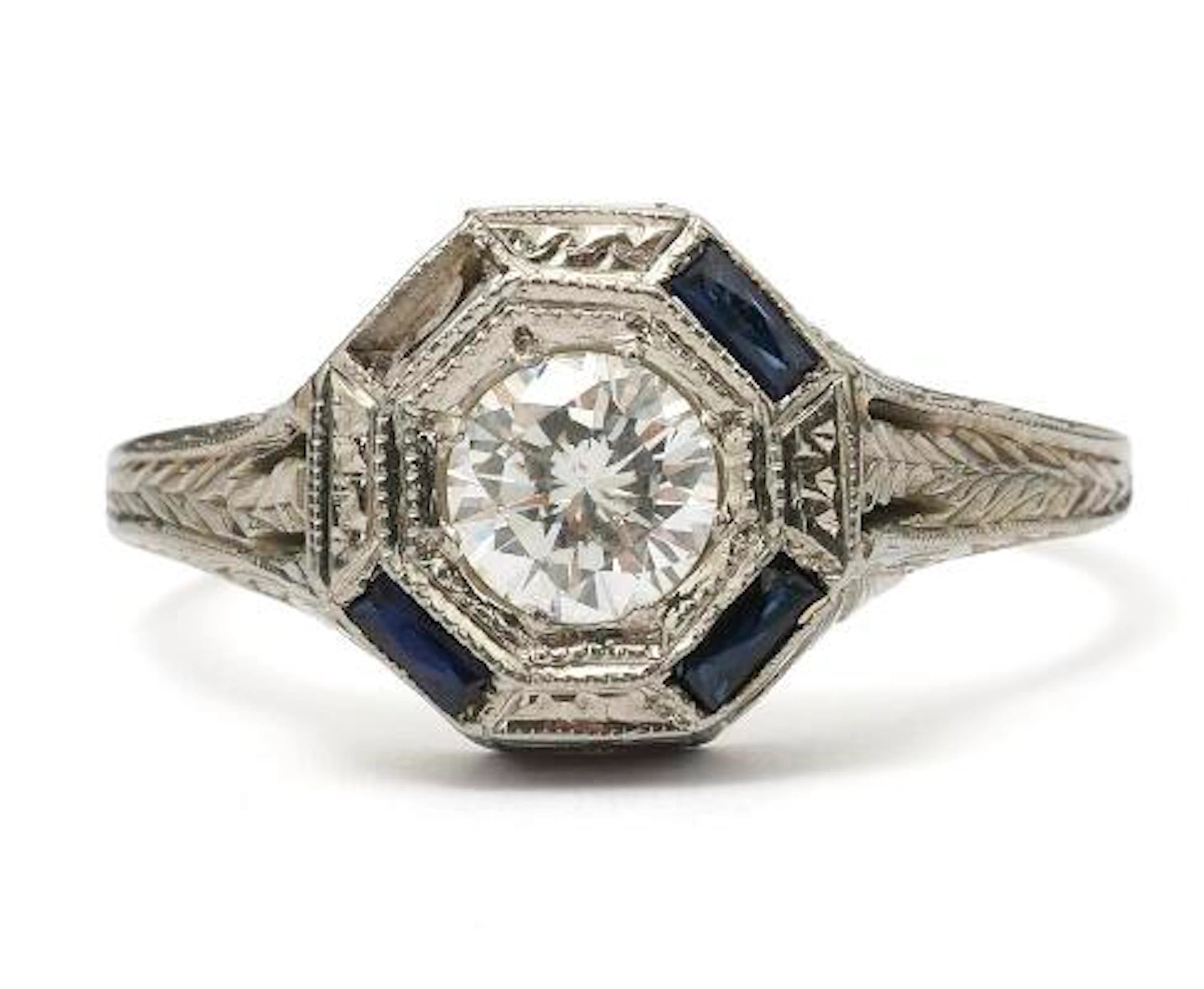 A diamond and sapphire ring set with a diamond and sapphires, mounted