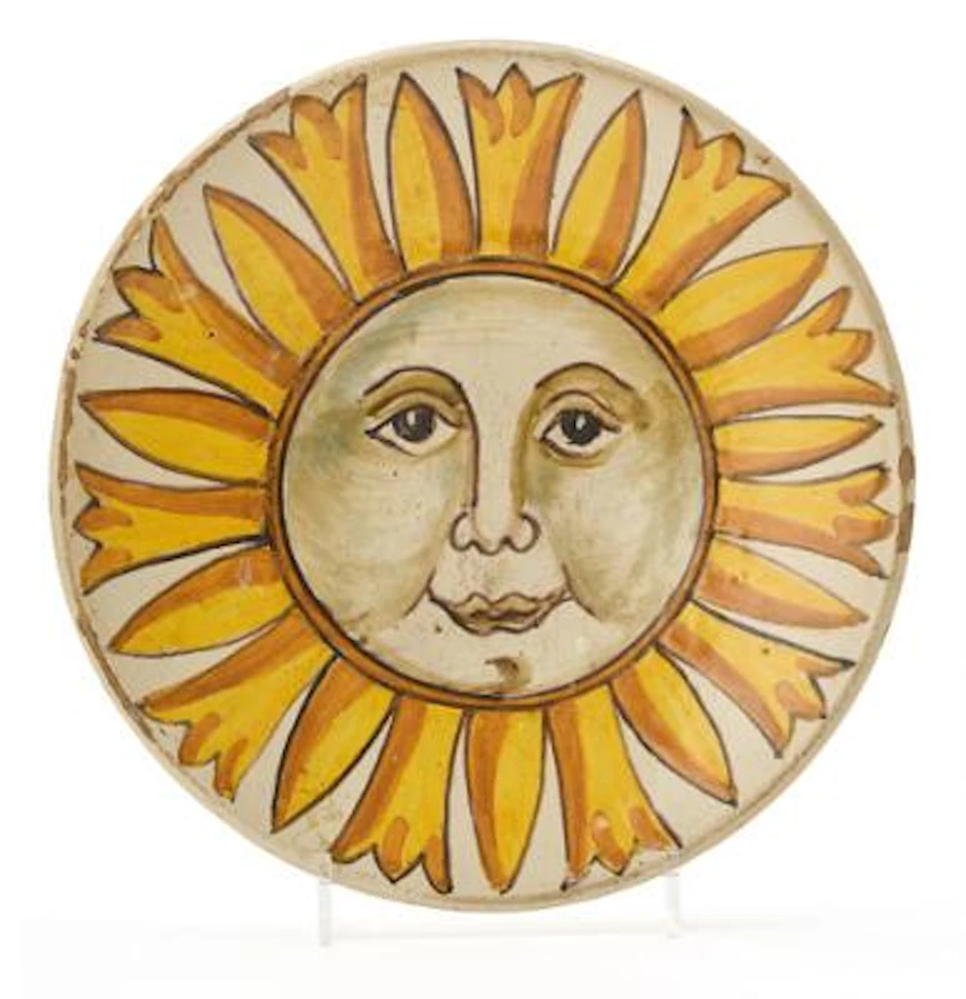 Majolica plate, decorated in yellow and sepia with full sun motif.