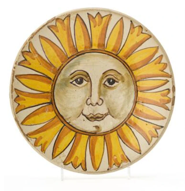 Majolica plate, decorated in yellow and sepia with full sun motif.