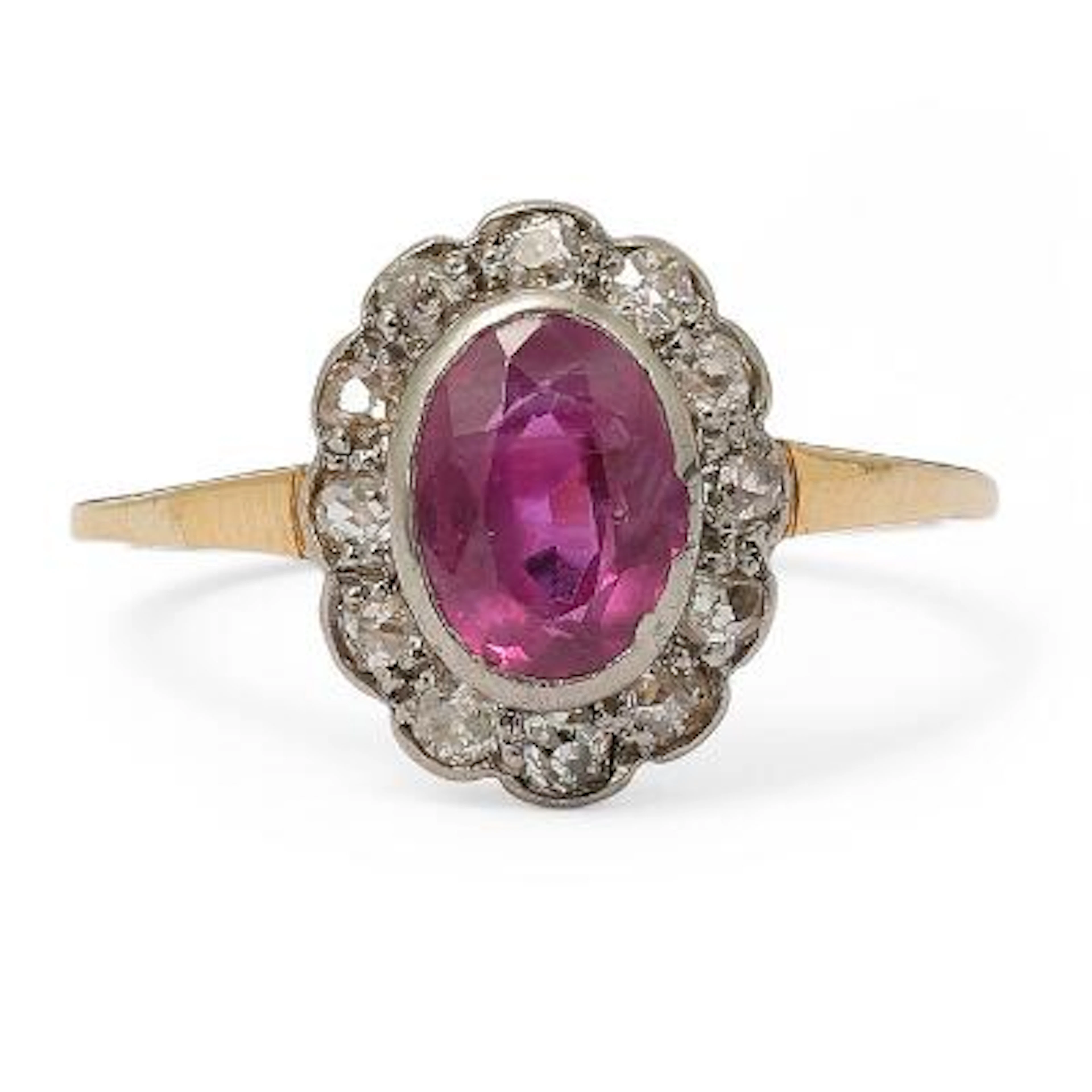 A sapphire and diamond ring set with a pink sapphire encircled by