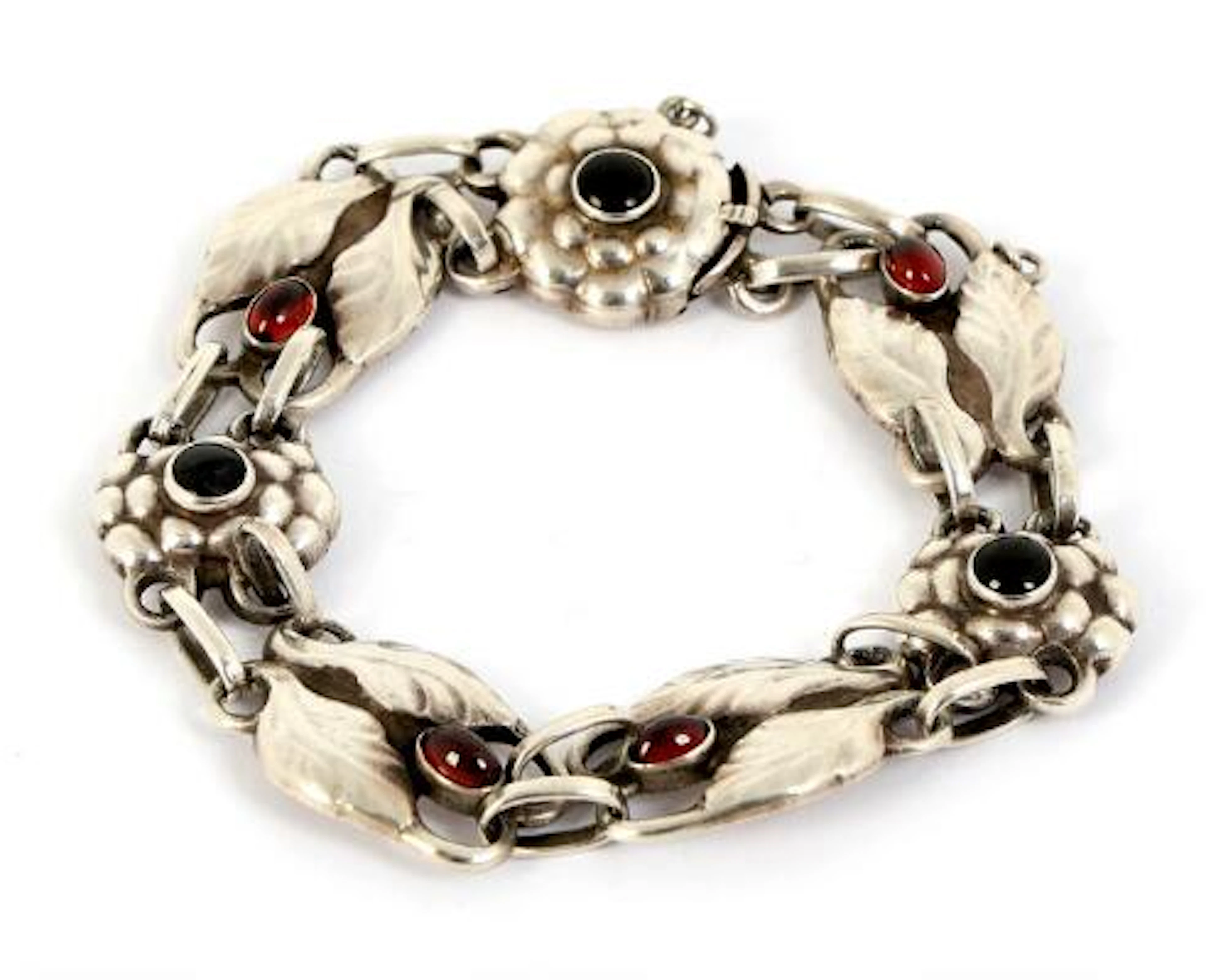 Georg Jensen: A garnet and onyx bracelet in the shape of foliage set