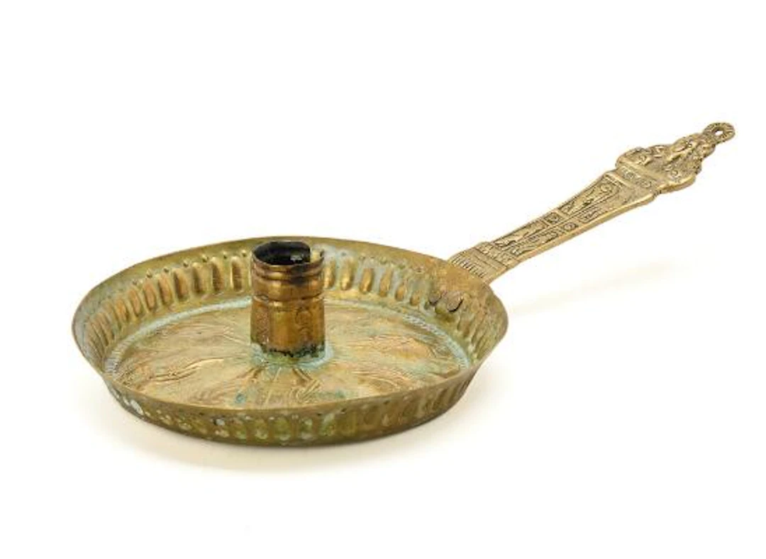 Chamberstick of cast and chased brass decorated with apostles. 17th