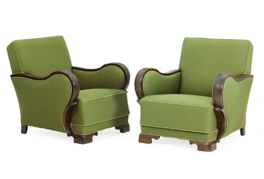 Danish furniture design: A pair of easy chairs with dark stained carved