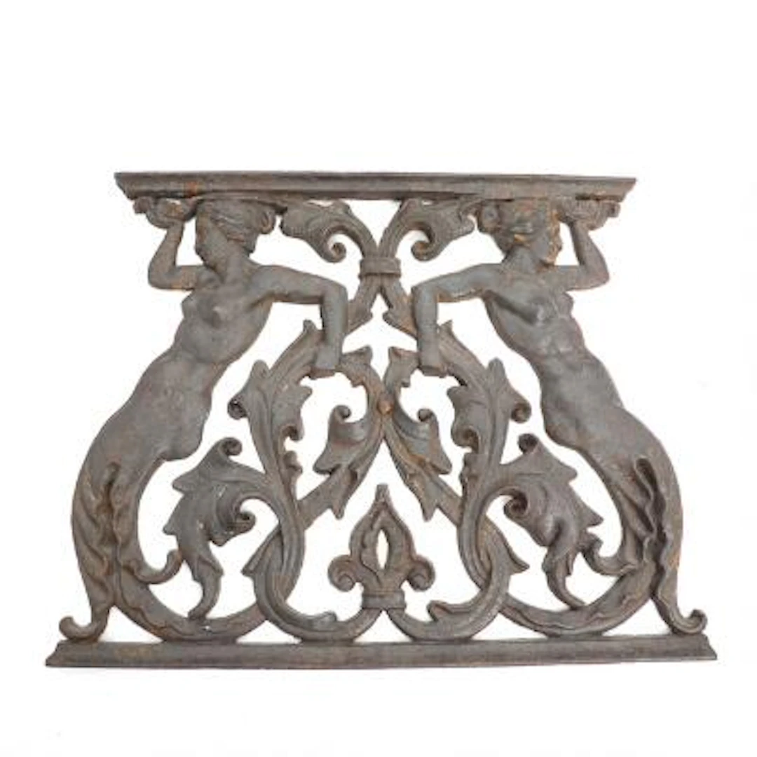 A patinated cast iron fireplace, cast in the shape of mermaids. 19th