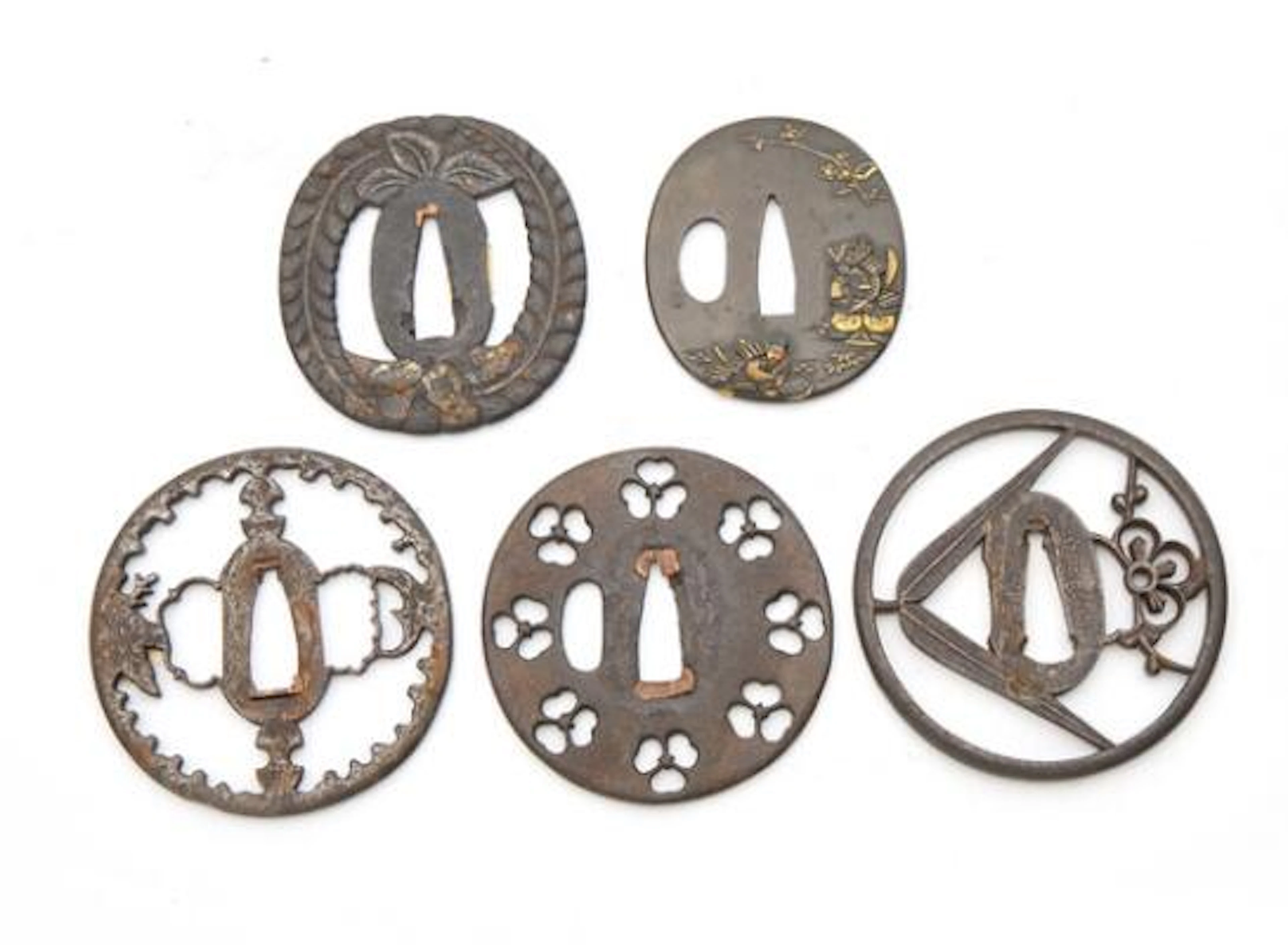 A collection of five iron Japanese tsuba of *maru-gata* (round) shape.