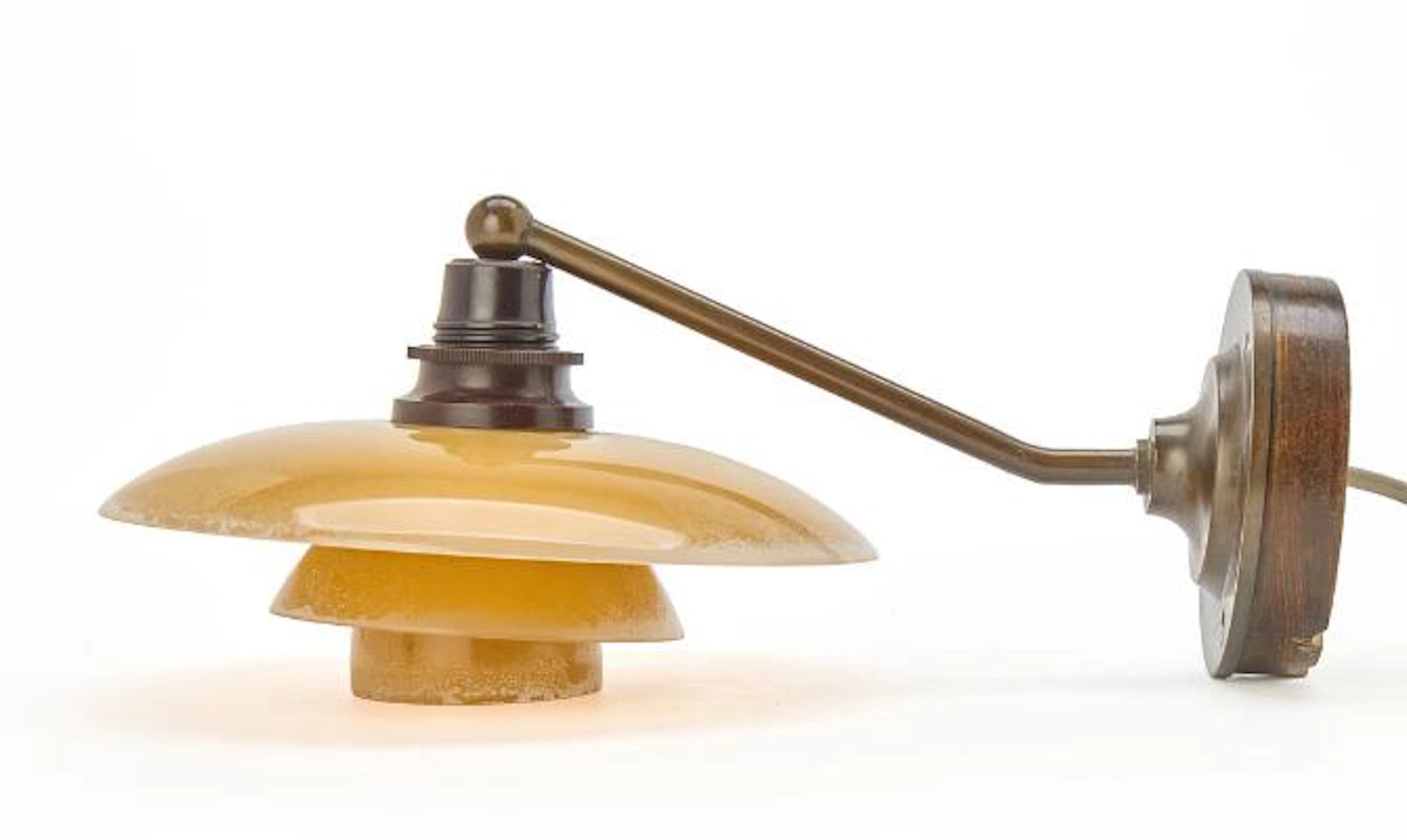 Poul Henningsen: "PH-2/1". Browned brass wall lamp with yellow coloured