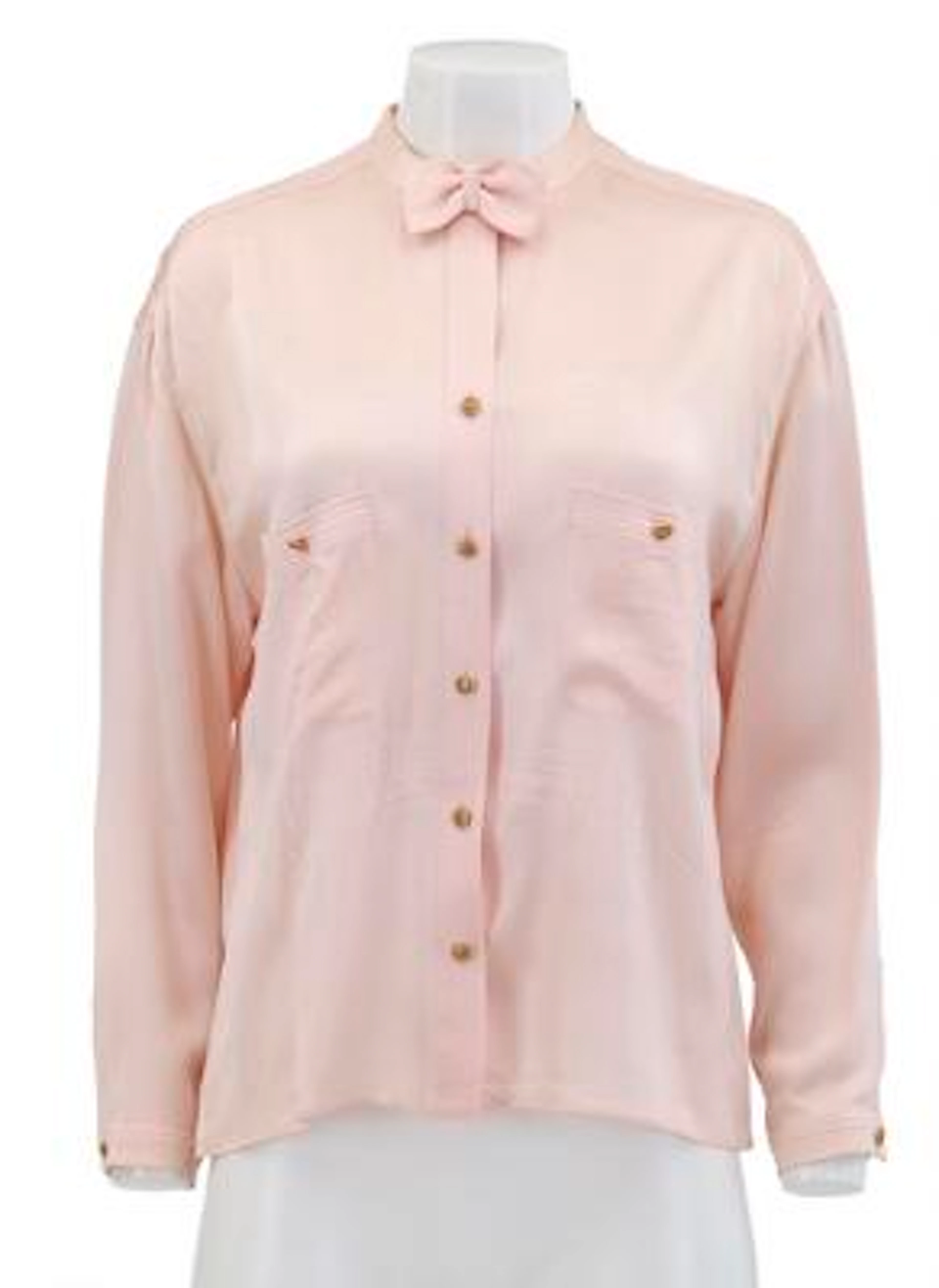 Chanel: A light pink silk blouse with a collar, buttons and two pockets.