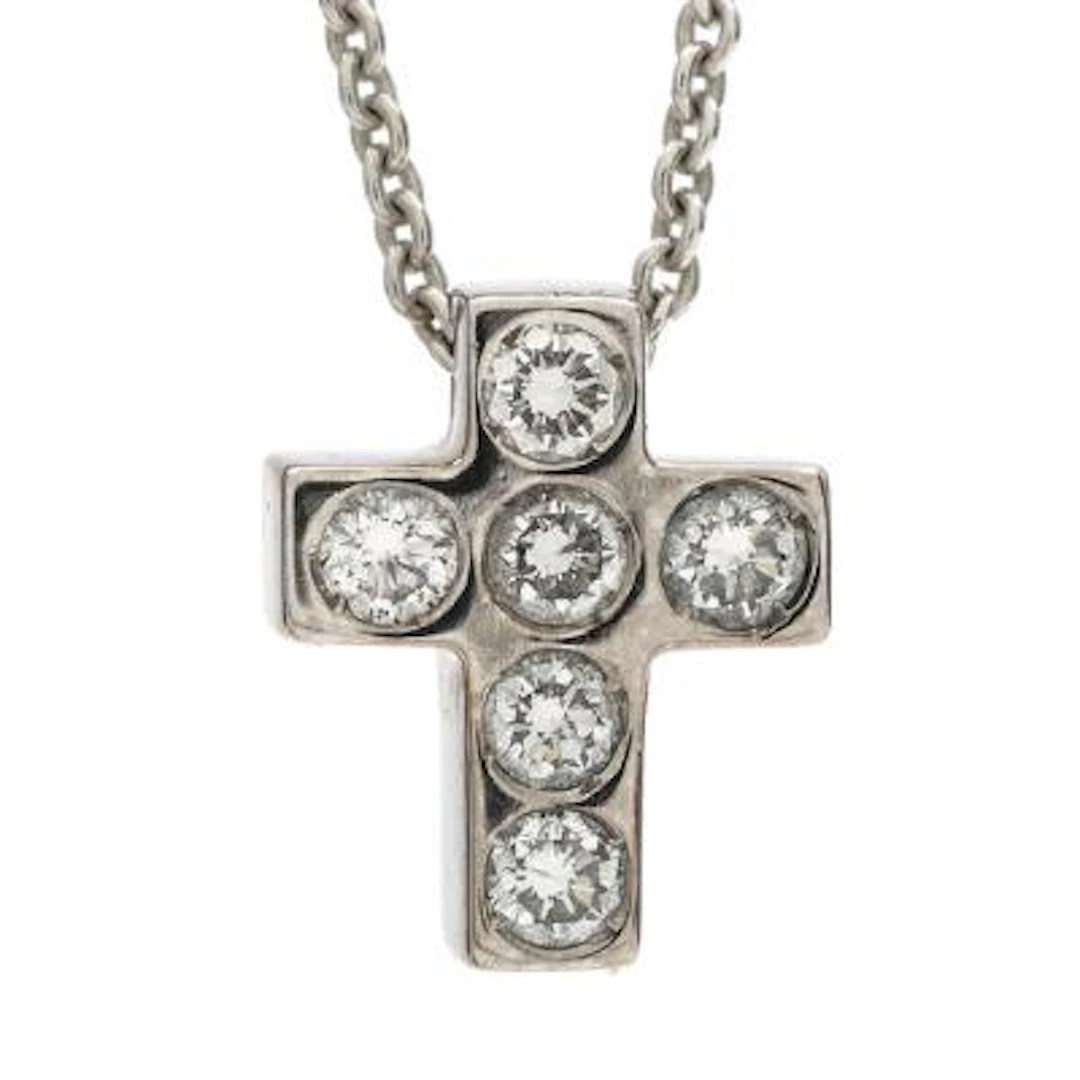 A diamond cross pendant set with brilliant-cut diamonds, mounted in