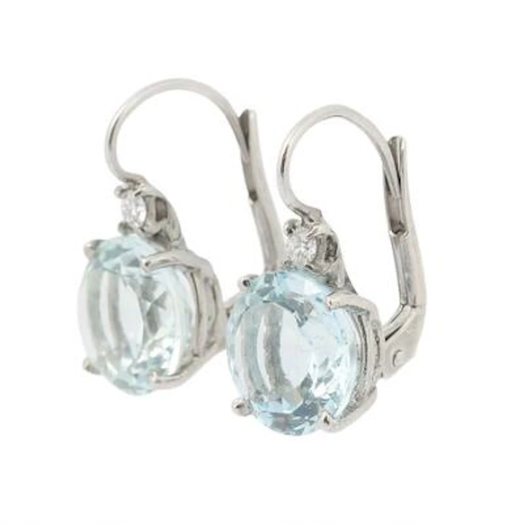 A pair of ear studs each set with an aquamarine and a diamond mounted