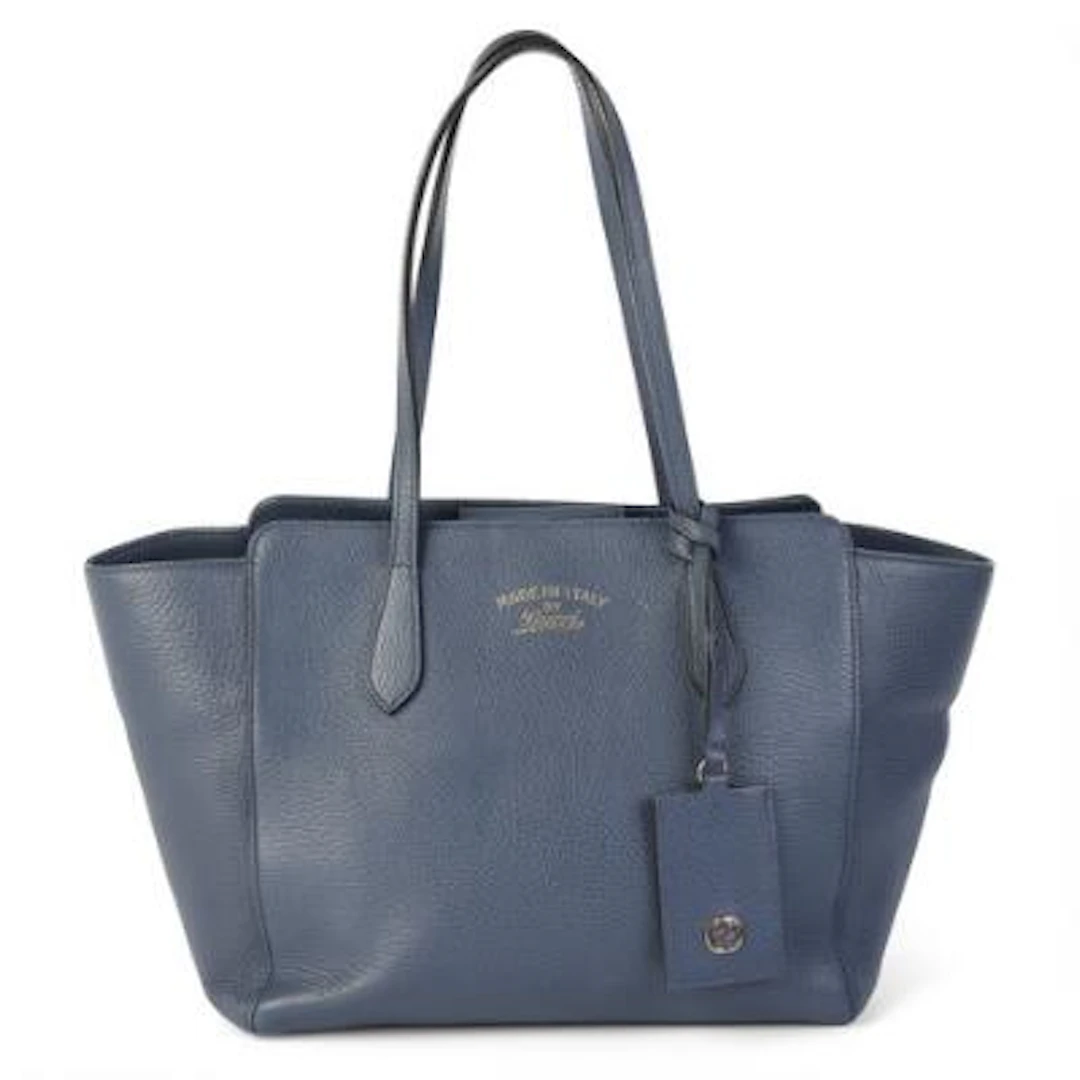 Gucci: A "Swing" tote bag of blue leather with gold tone hardware