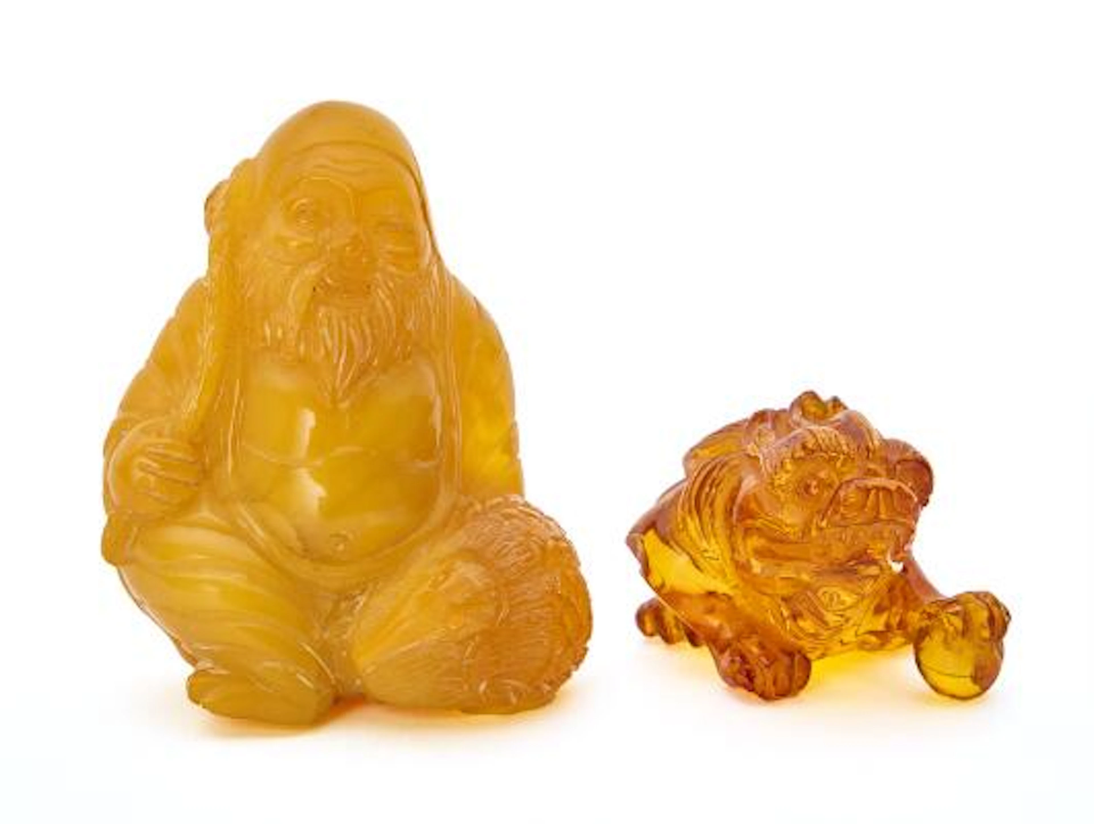 Two figures of carved Baltic amber in the form of a Chinese coin frog