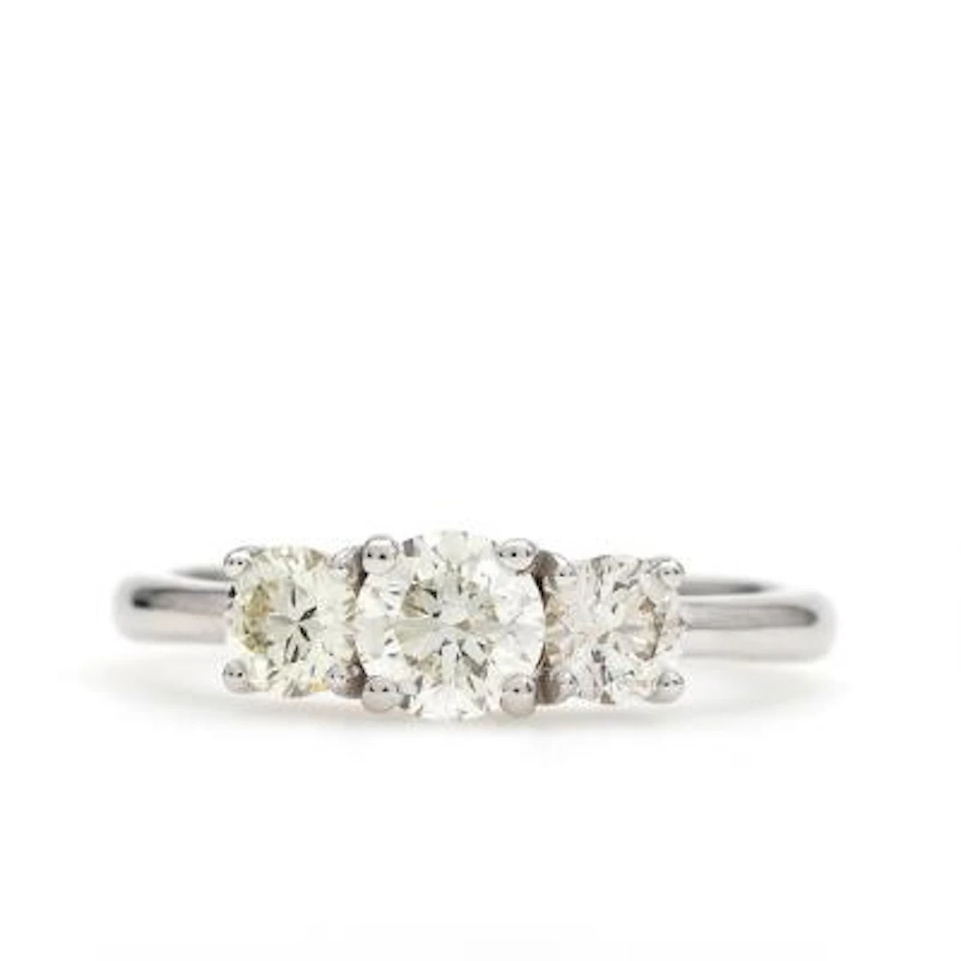 A diamond ring set with three brilliant-cut diamonds weighing a total