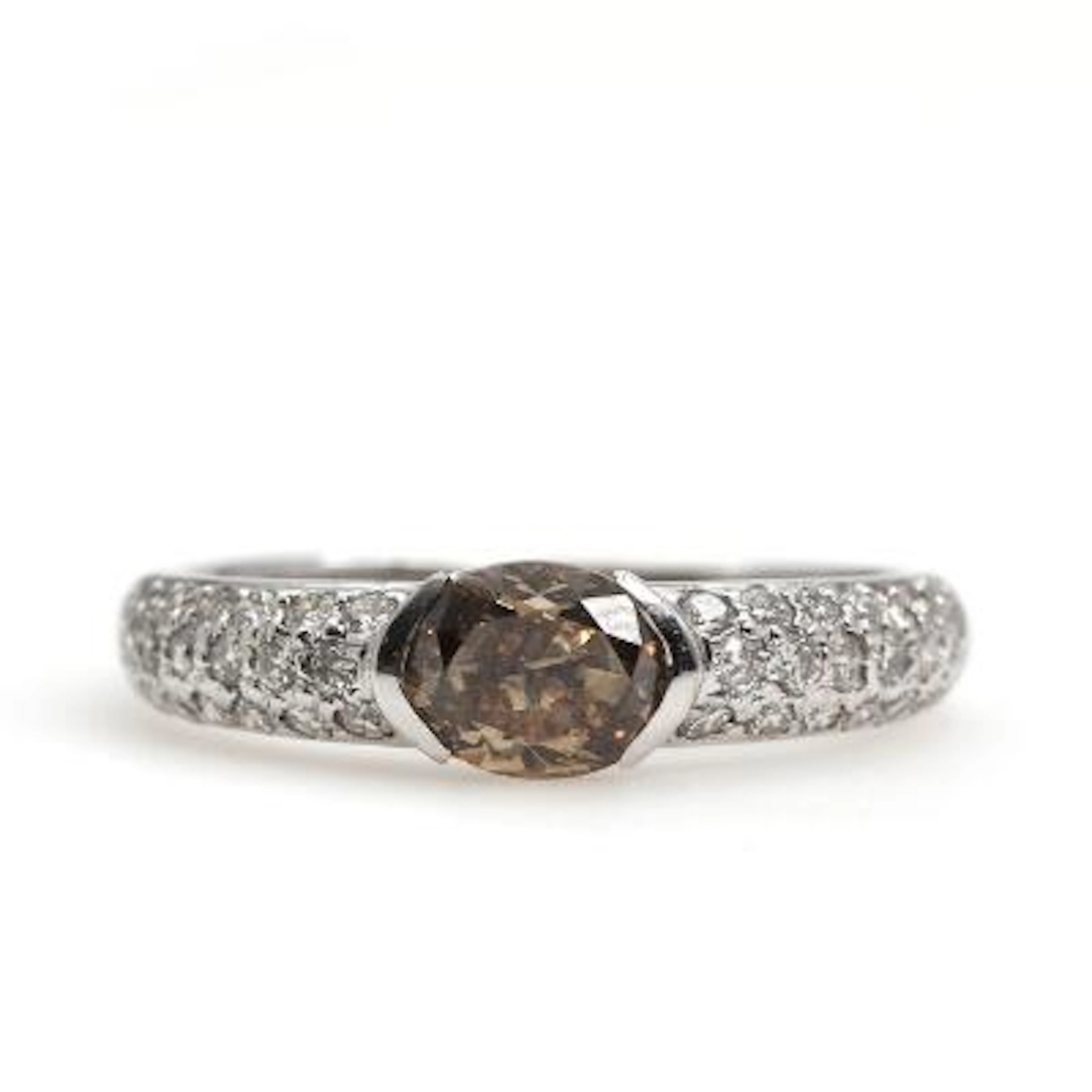 A diamond ring set with a brilliant-cut cognac diamond flanked by