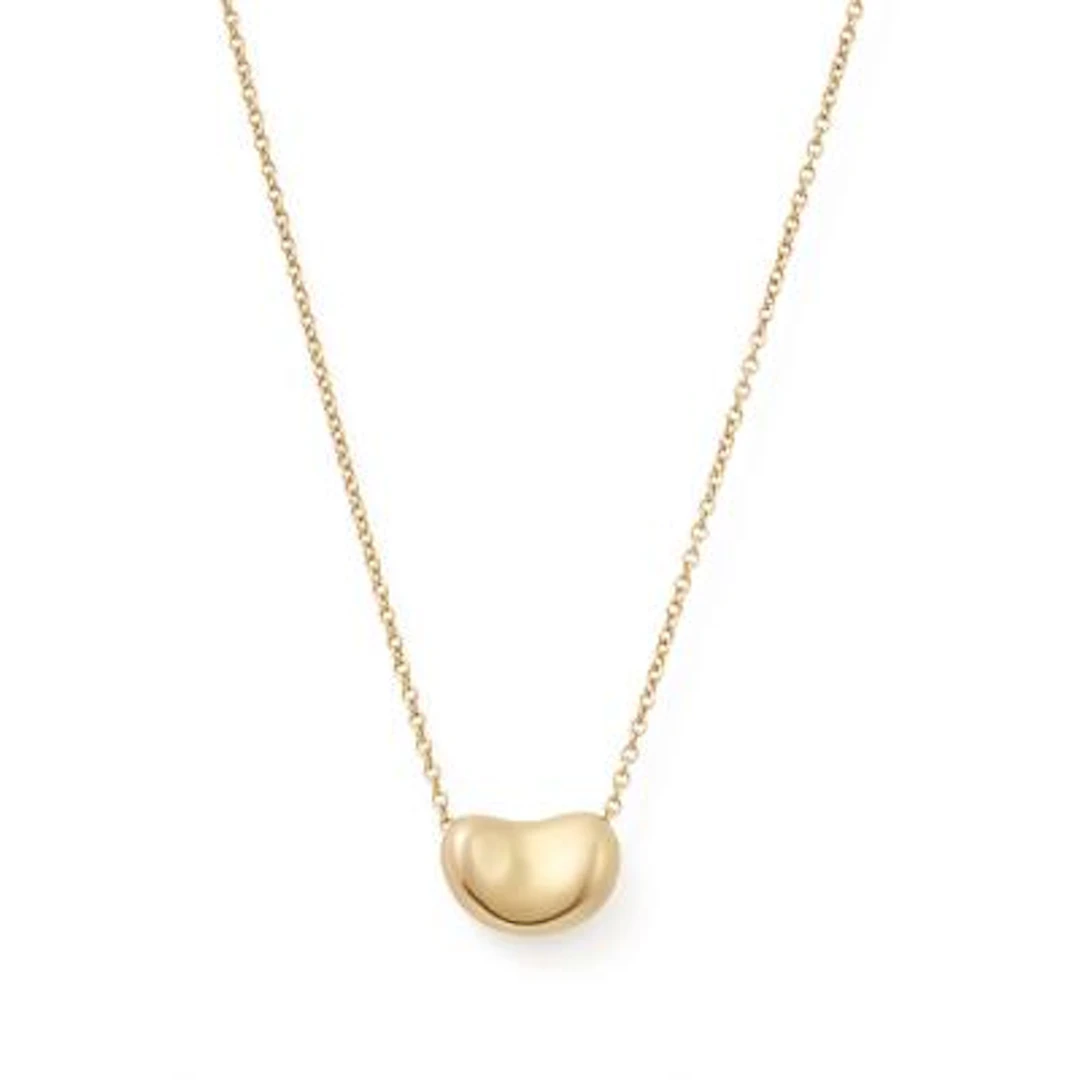 Tiffany & Co.: A "Bean" necklace set with a pendant of 18k gold. Design