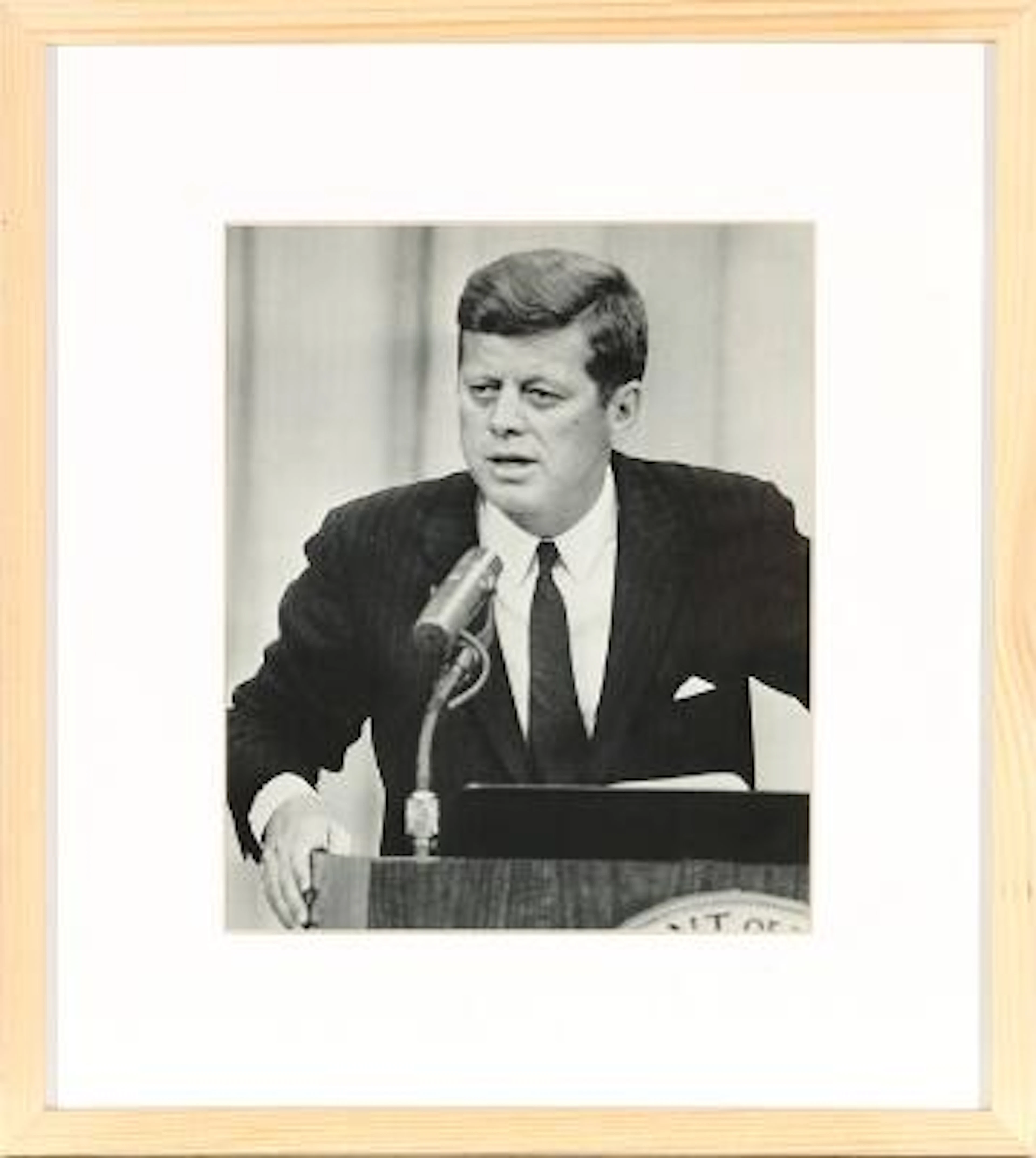 John F. Kennedy during a press conference. Black-and-white silver