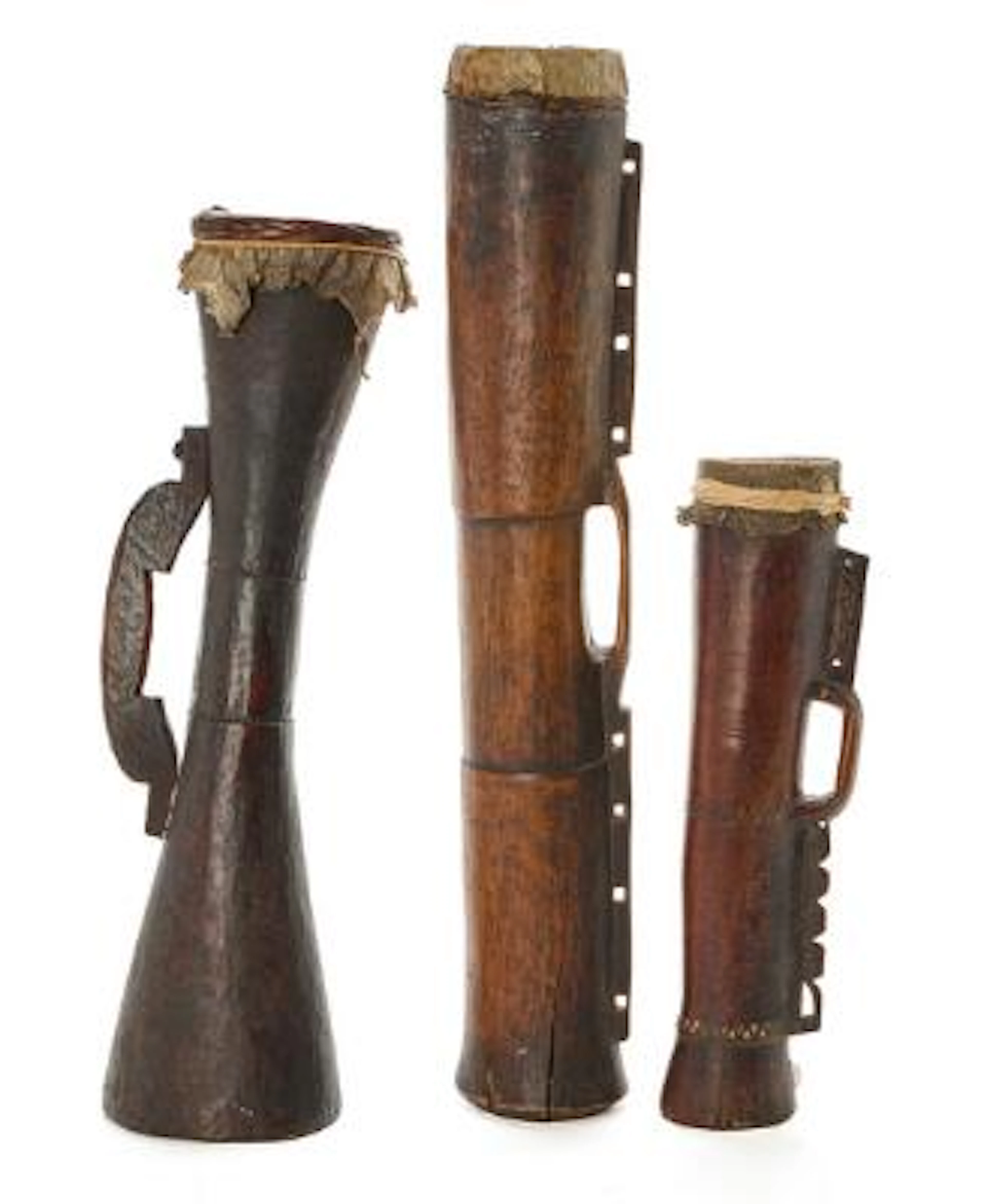 Three ceremonial drums of carved patinated wood covered with Iguana