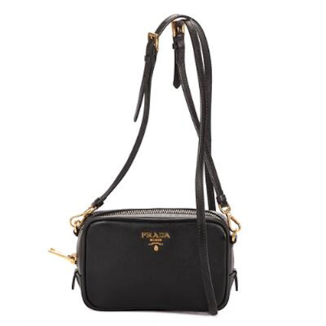 Prada: A "Mini Zip Crossbody" bag in black Saffiano Lux-leather with